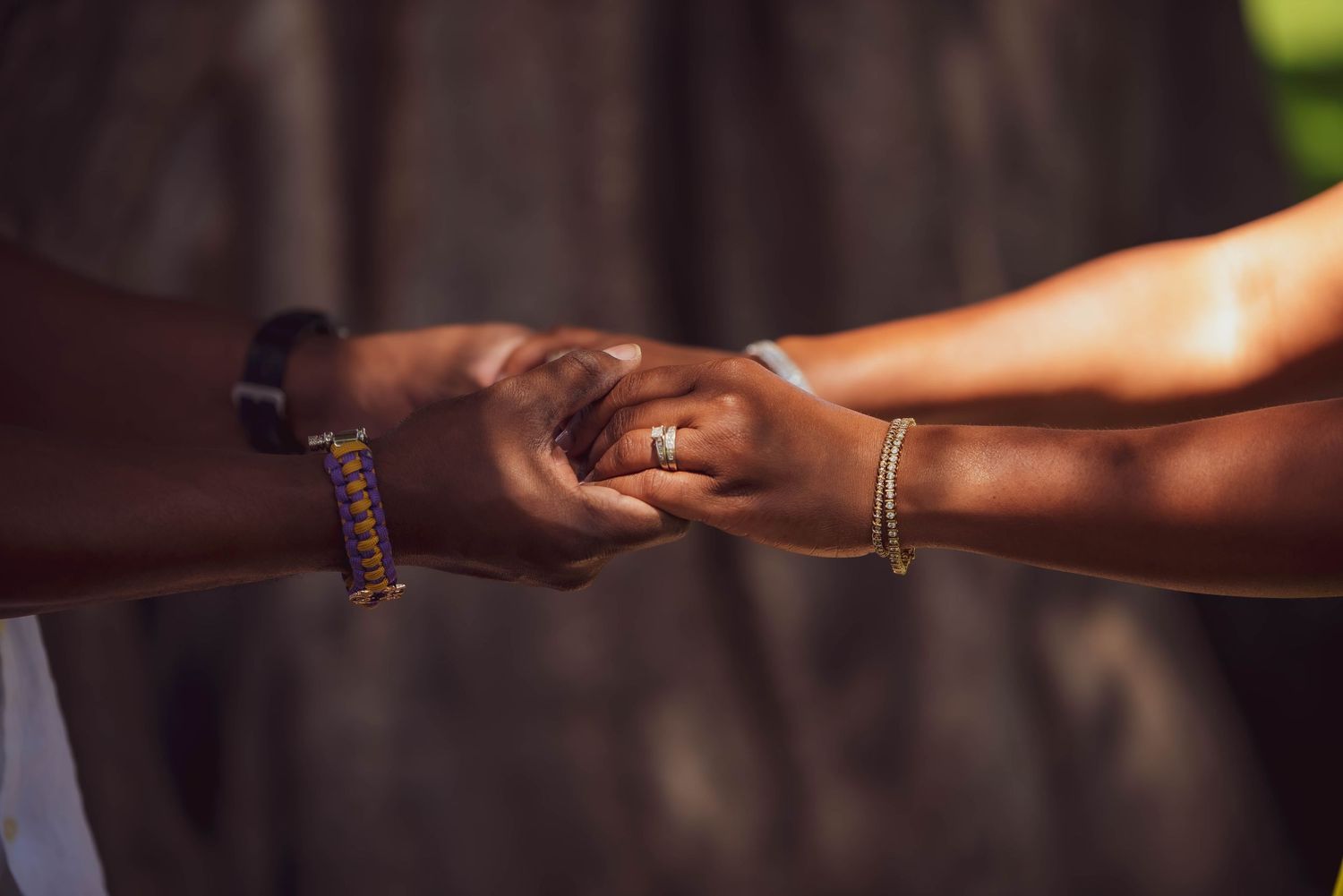 Close-up of hands reaching out to connect in warm natural lighting.