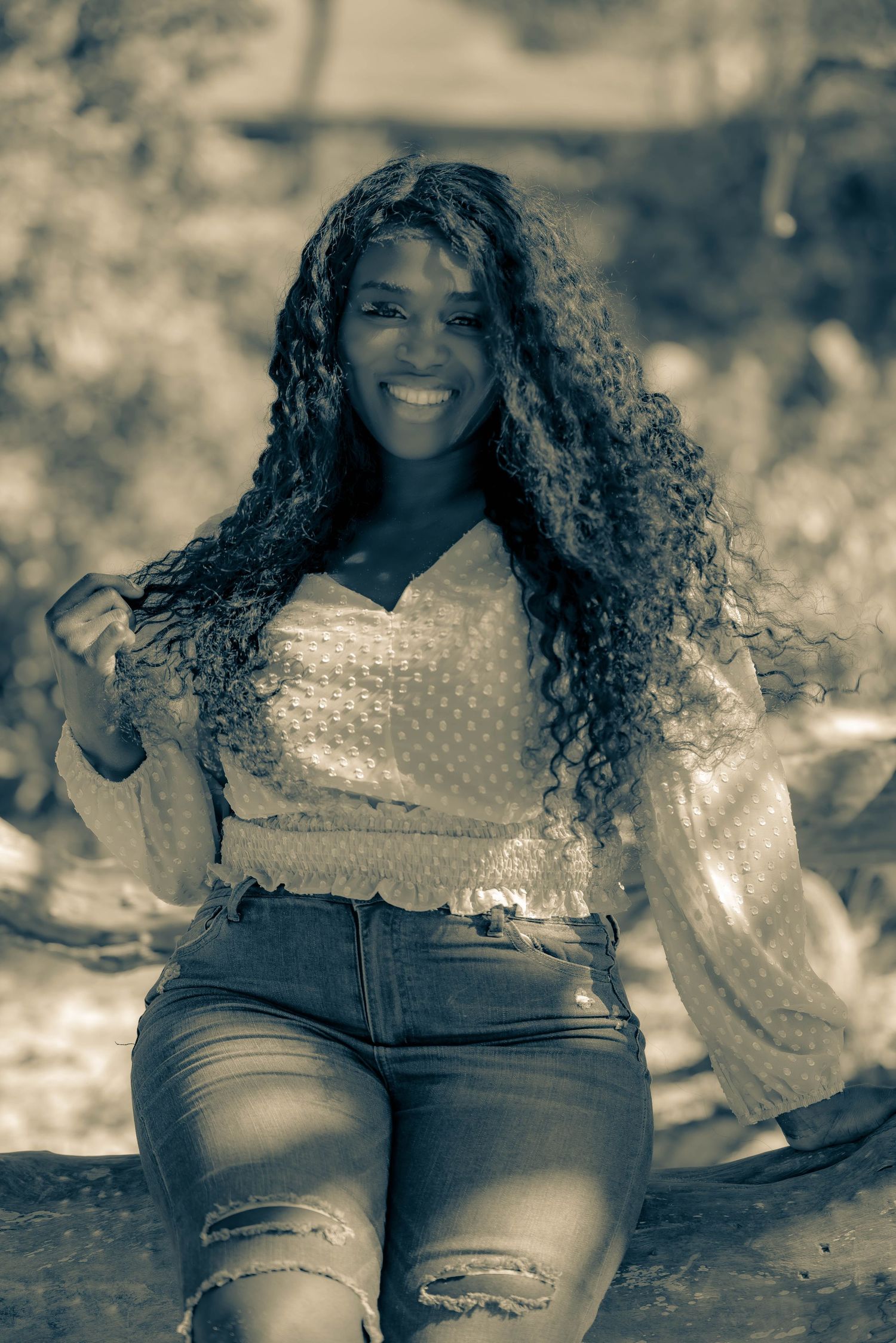 Sepia-toned outdoor portrait series featuring casual denim and textured top.