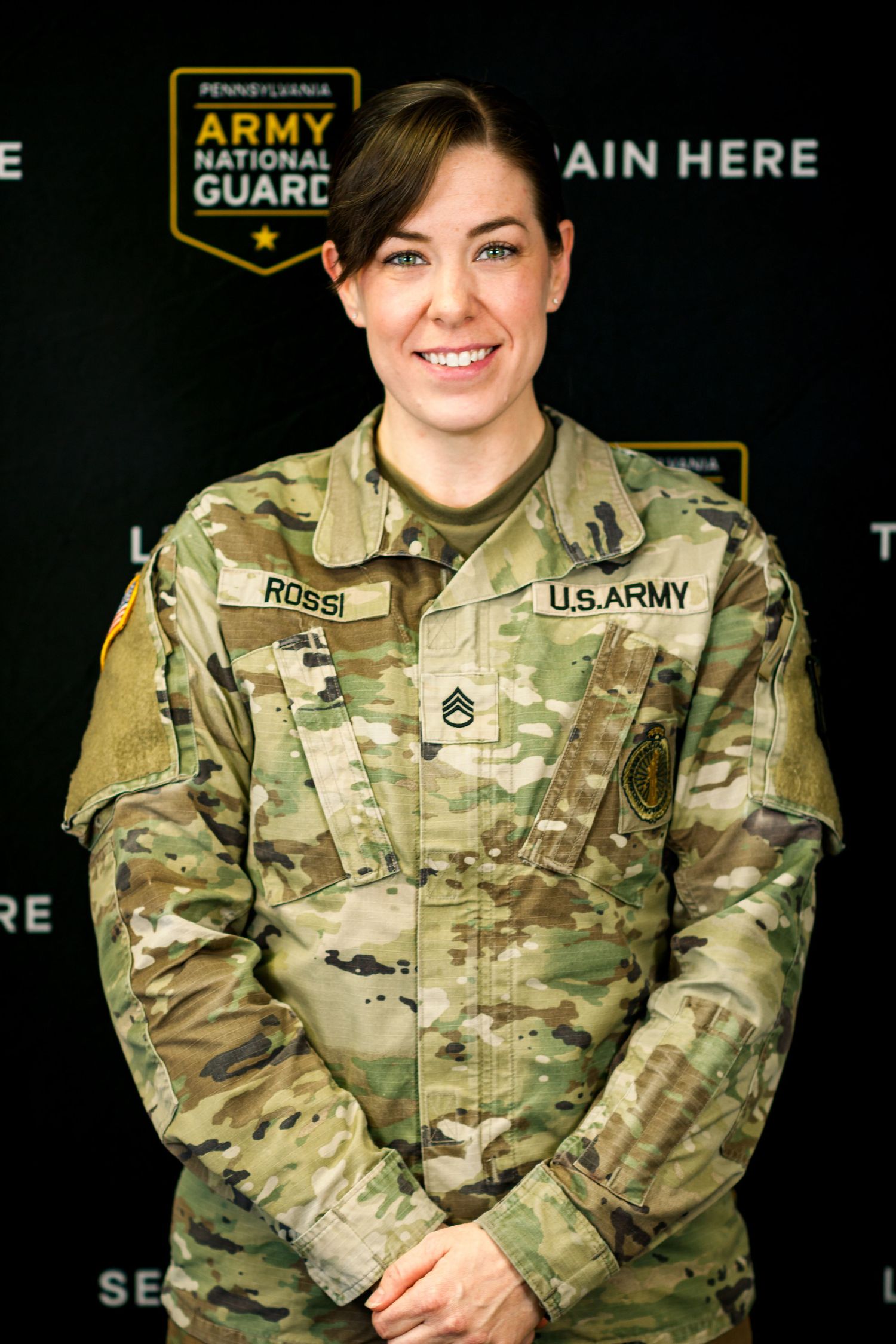 Military portrait series showing service member in camouflage uniform against dark background.