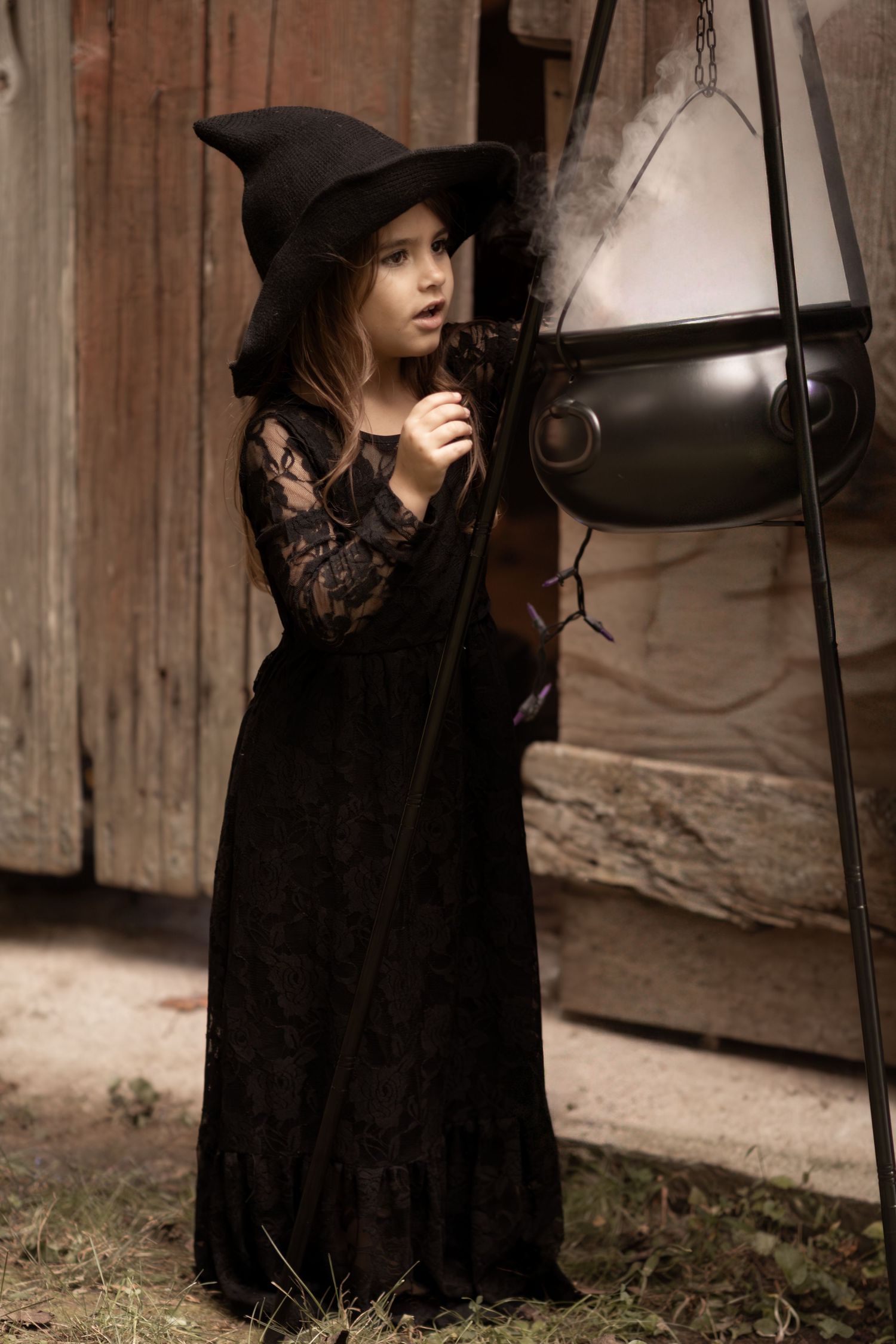 Artistic portrait series showing a figure in black clothing and hat against a rustic wooden backdrop.
