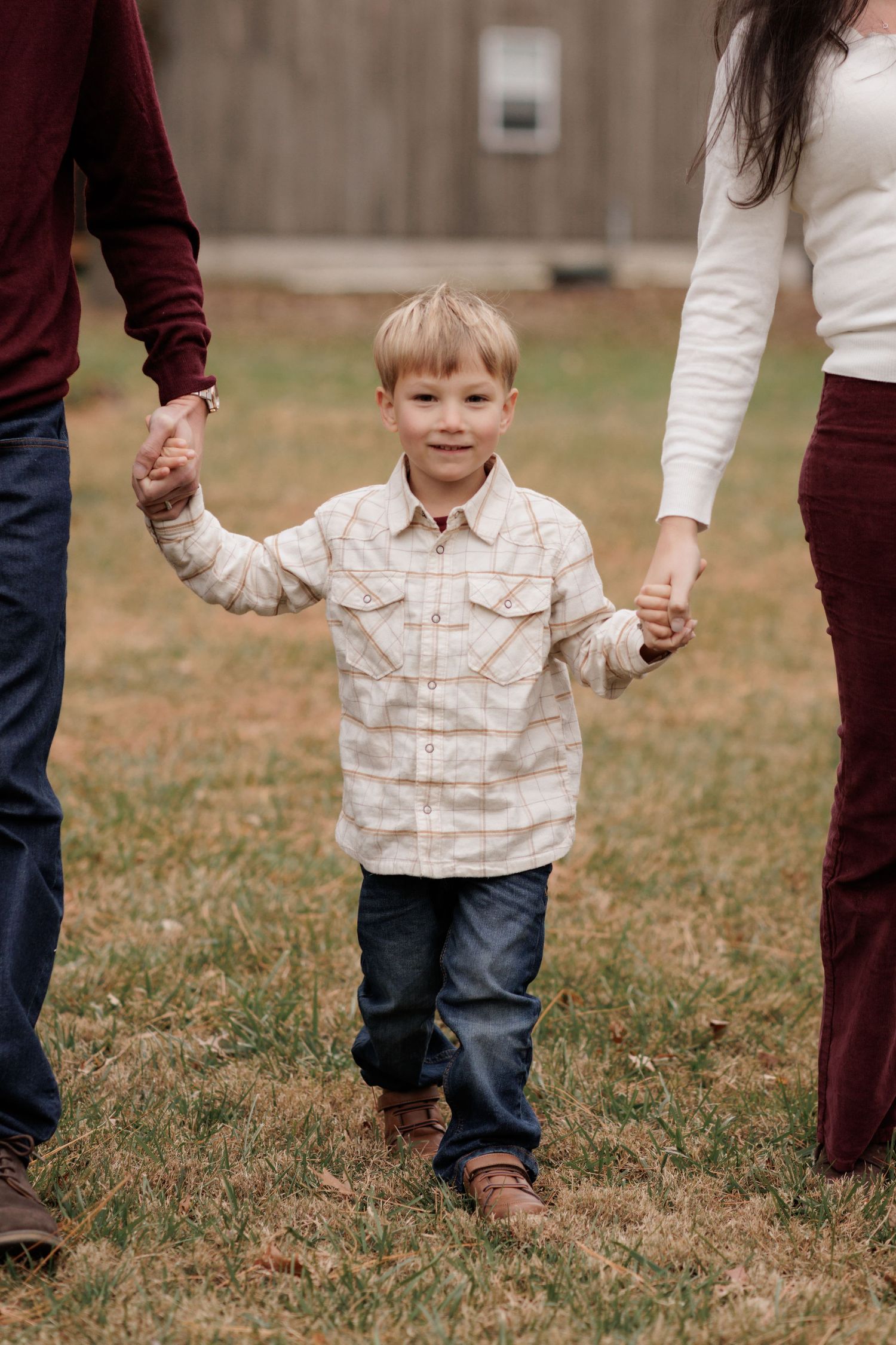 Series of walking shots showing family holding hands in casual outdoor setting.