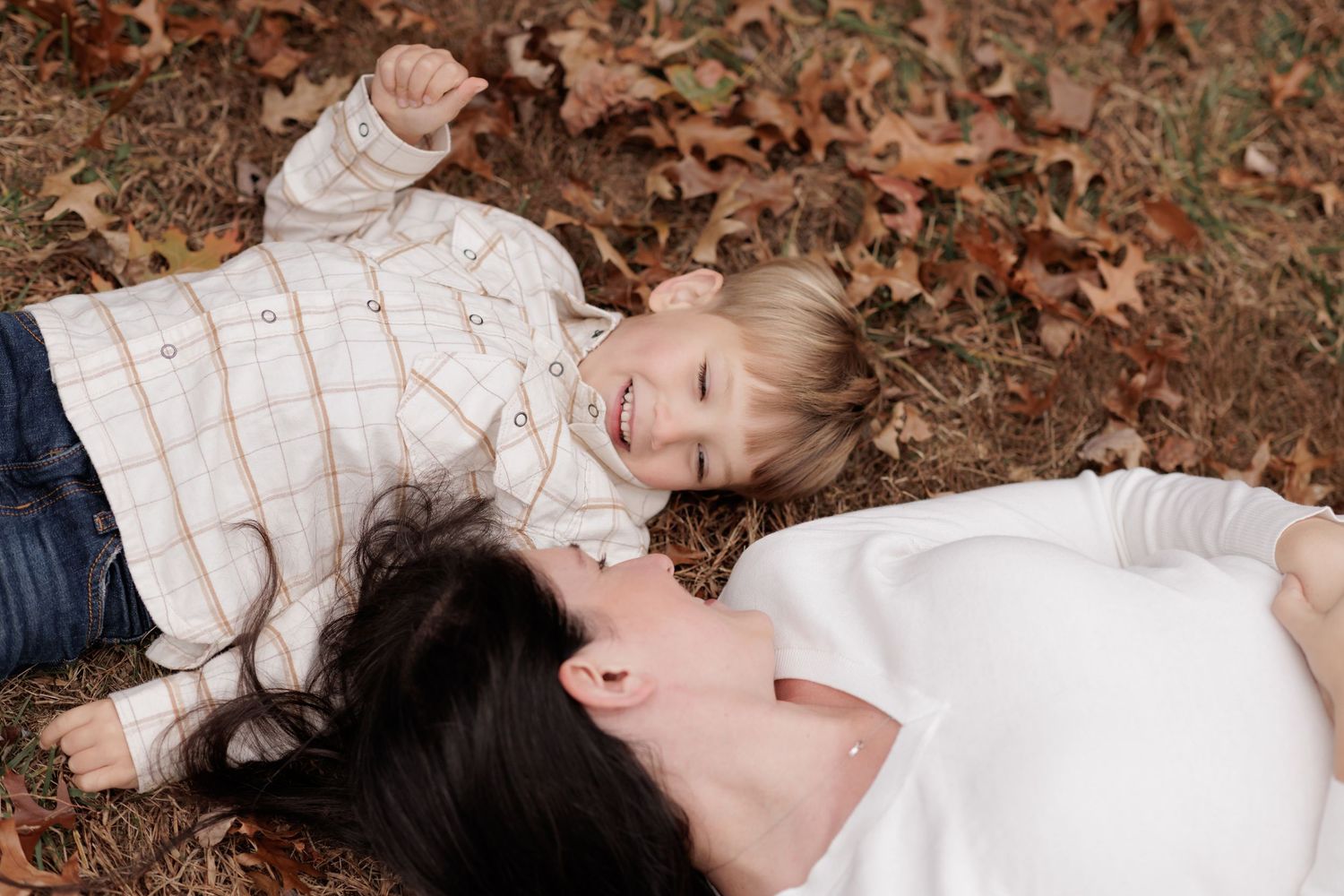 A series of connected photos showing someone lying on autumn leaves in a white dress, creating a dreamy outdoor scene.