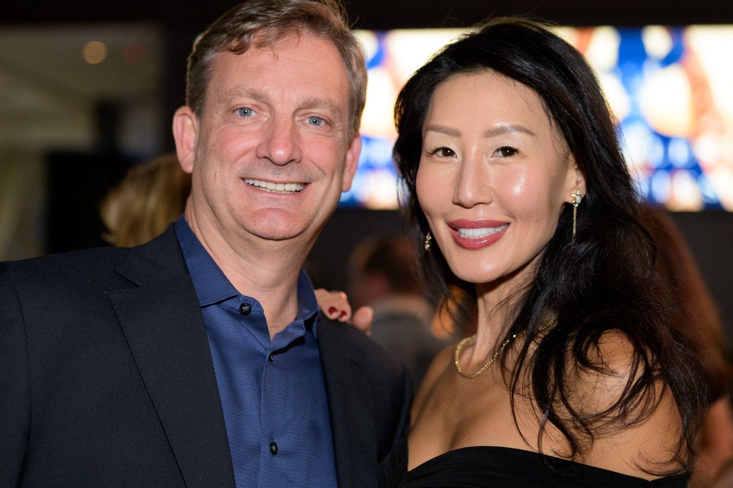 Smiling couple poses together at the Bridles and Bowties charity gala evening event.
