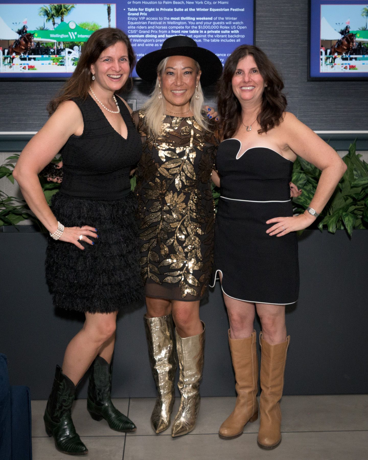 Three women in cocktail attire pose together at the Bridles and Bowties gala.