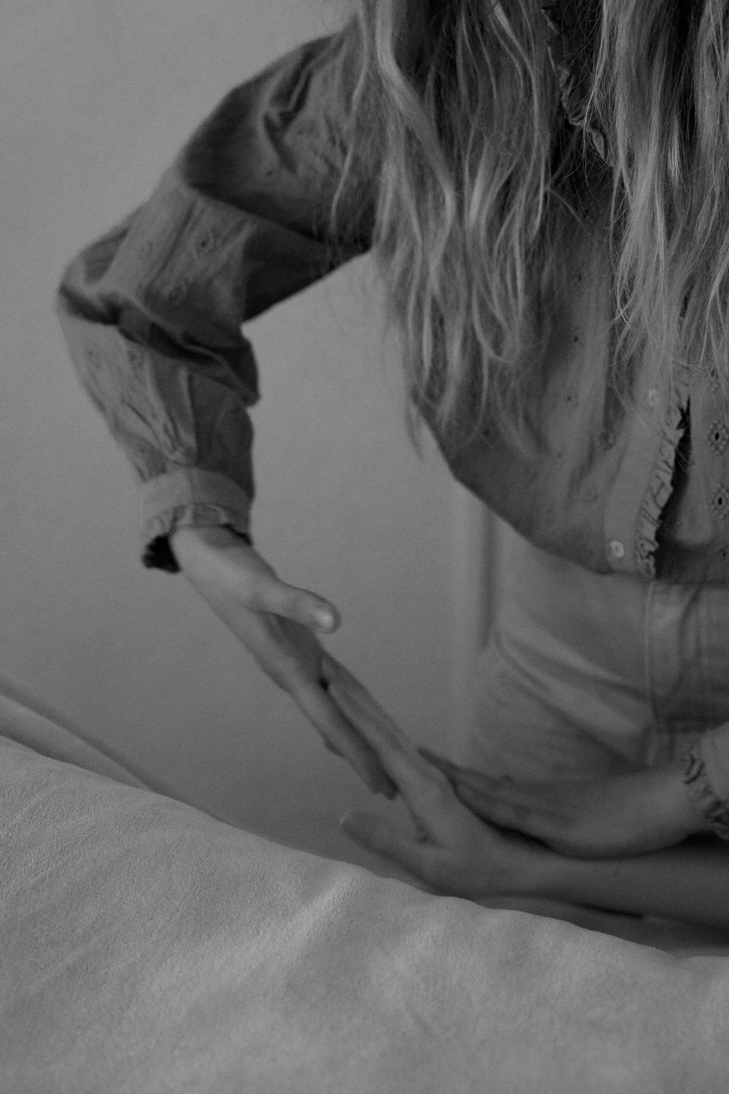 Monochromatic sequence capturing graceful downward motion with long hair and flowing fabric.