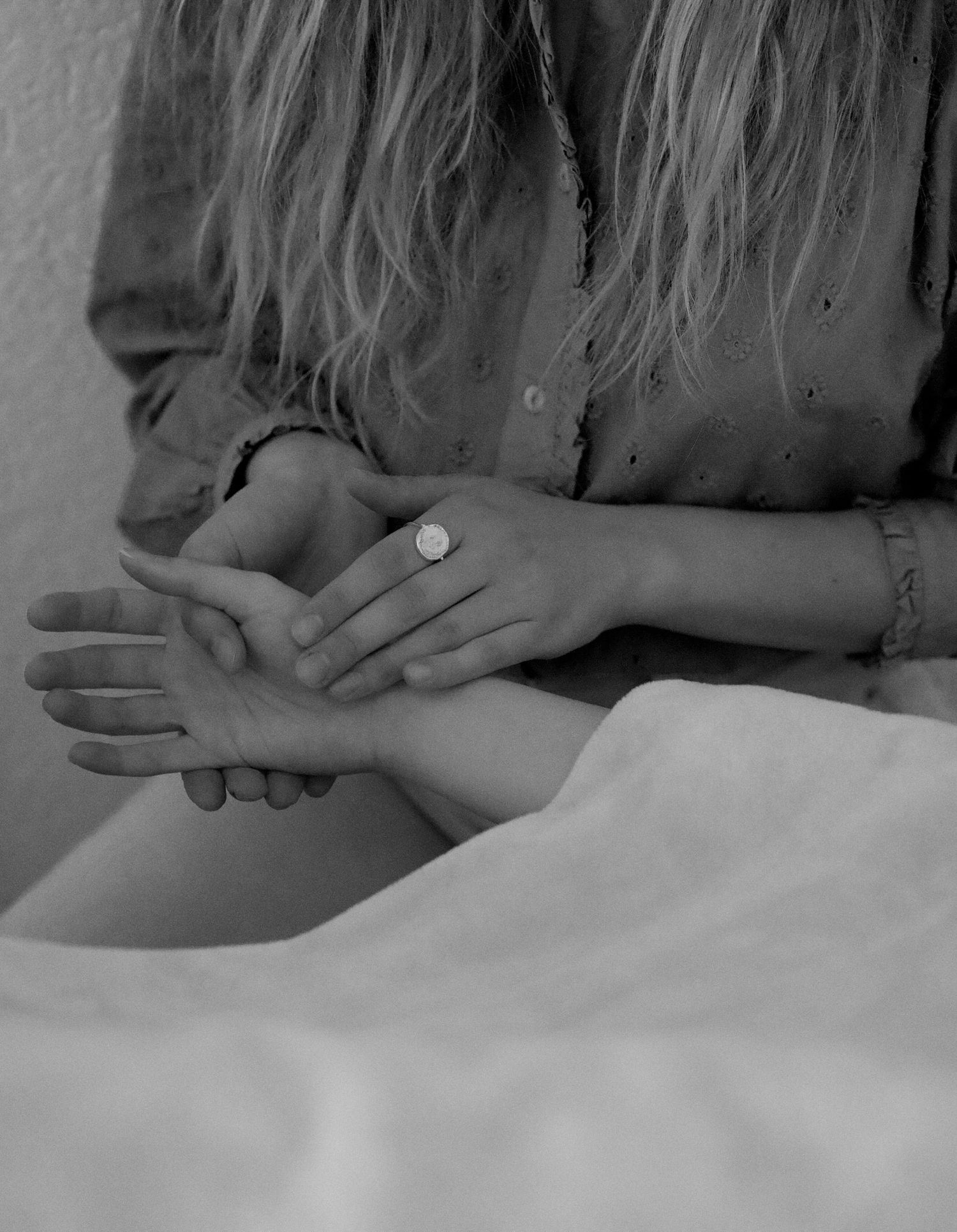 A series of black and white photographs showing hands performing a massage technique on a person's back.