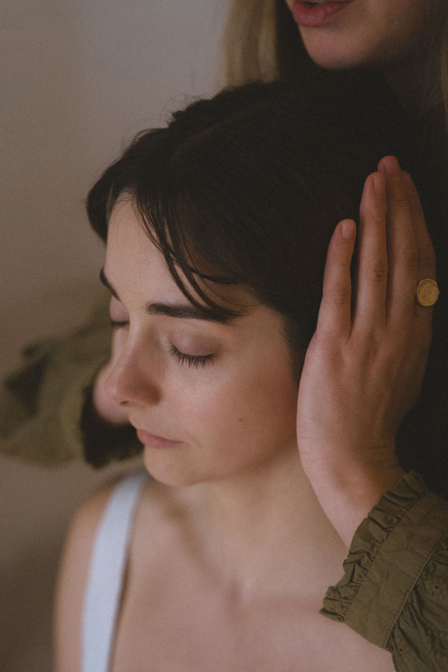 A series of photos showing a person with short dark hair listening intently with eyes closed and hands cupped around ears.