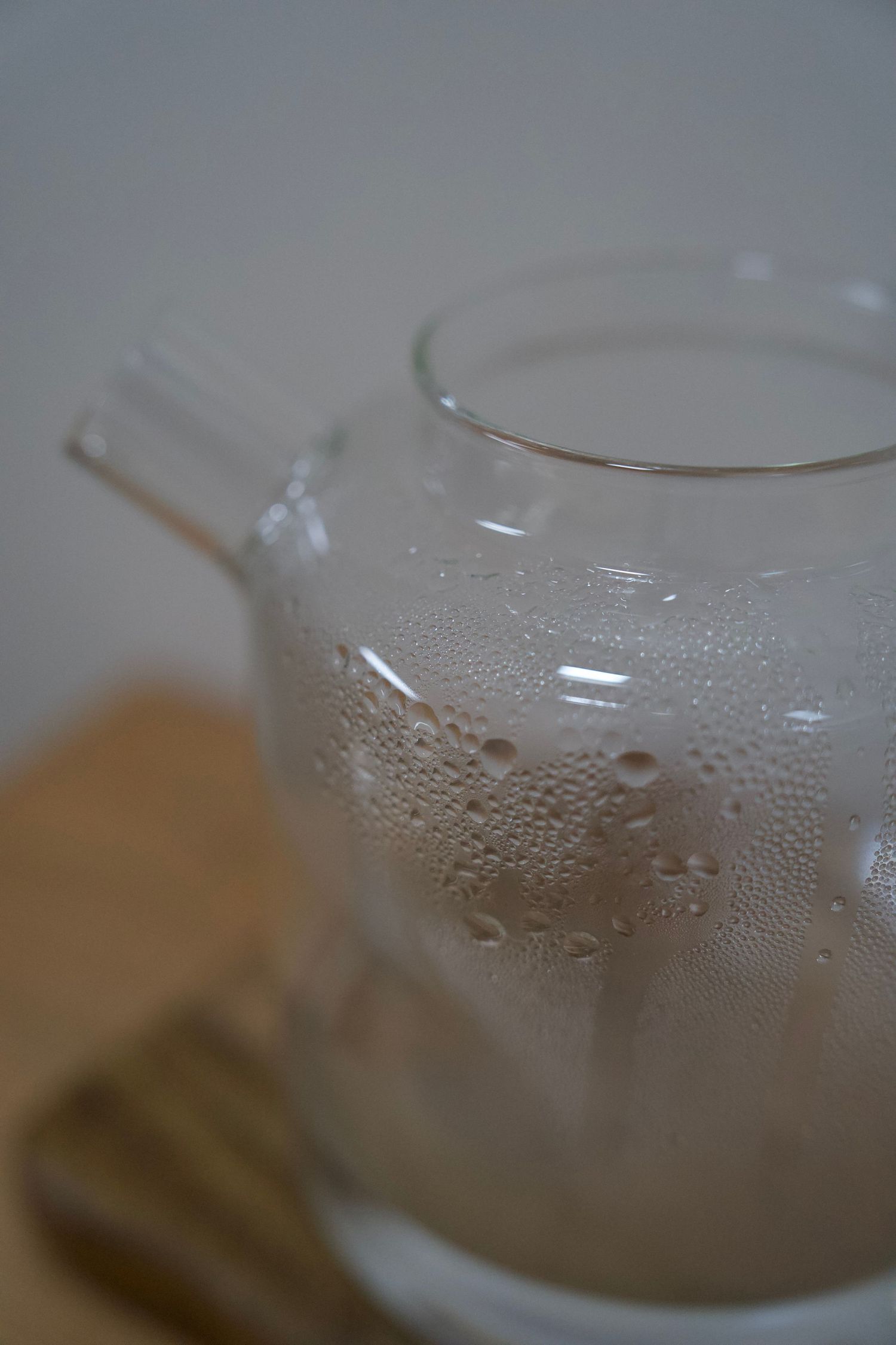 Close-up of condensation on glass teapot surface.
