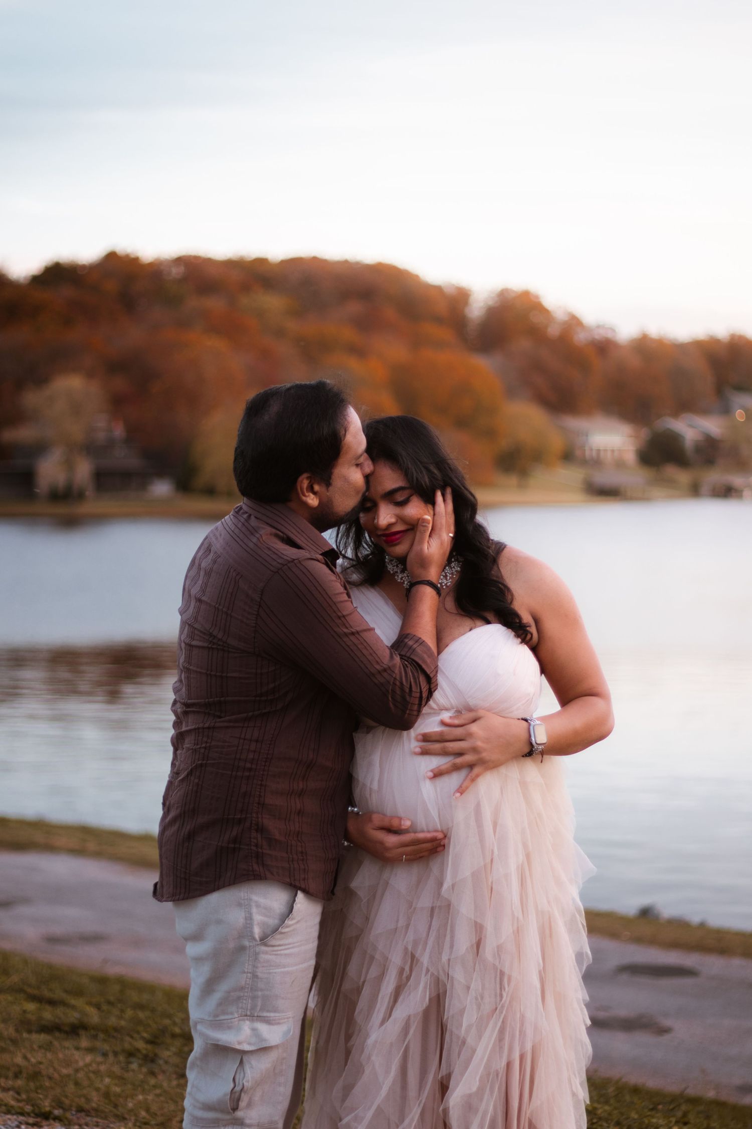 Expecting couple embracing during outdoor maternity session in Northwest Arkansas