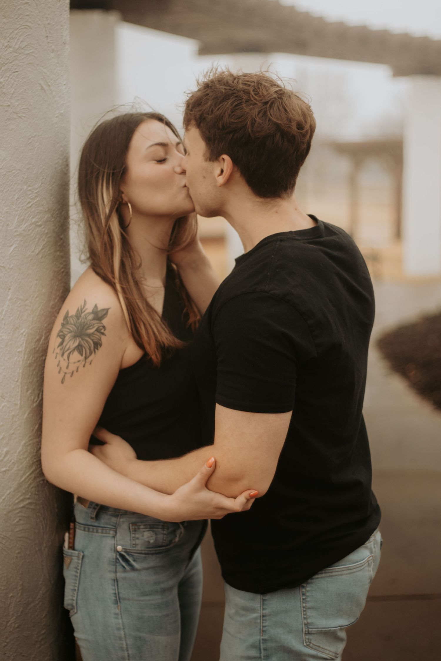 Couple kissing at Osage P{ark in Bentonville Arkansas, during a couples shoot.