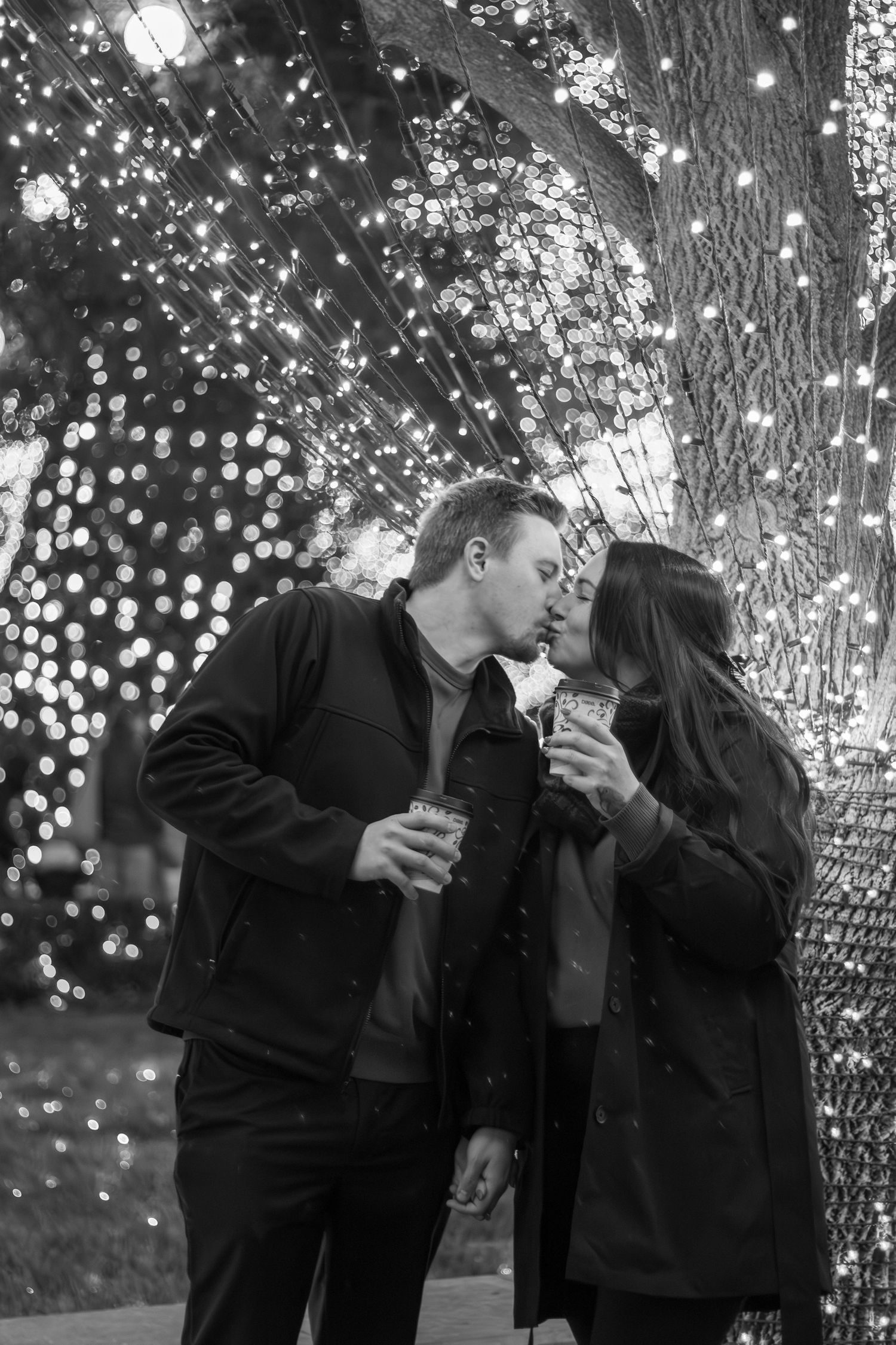 Cute couple smiling at each other during a couples session at downtown Bentonville Arkansas
