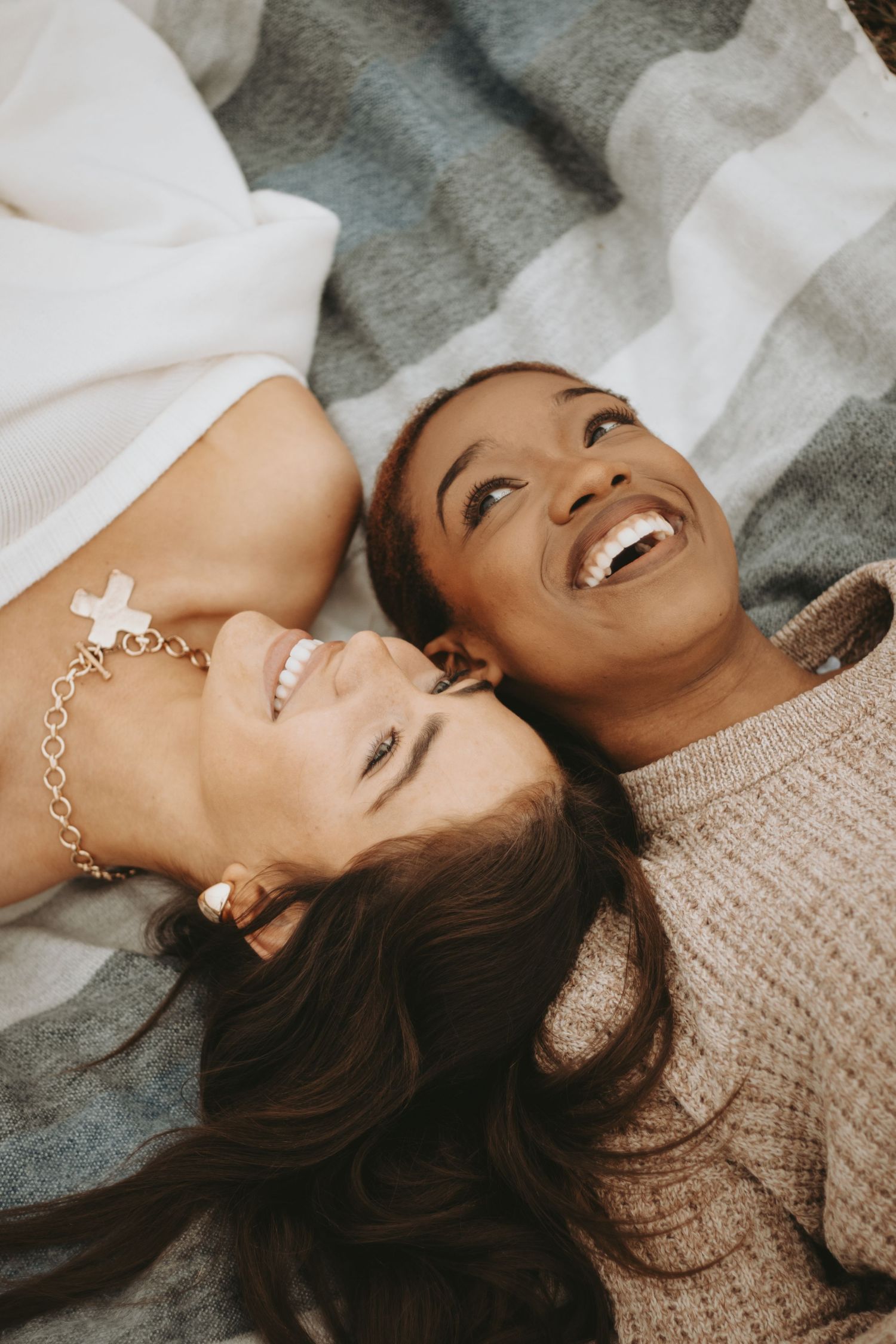 Best friends laughing during outdoor photoshoot in Bentonville Arkansas