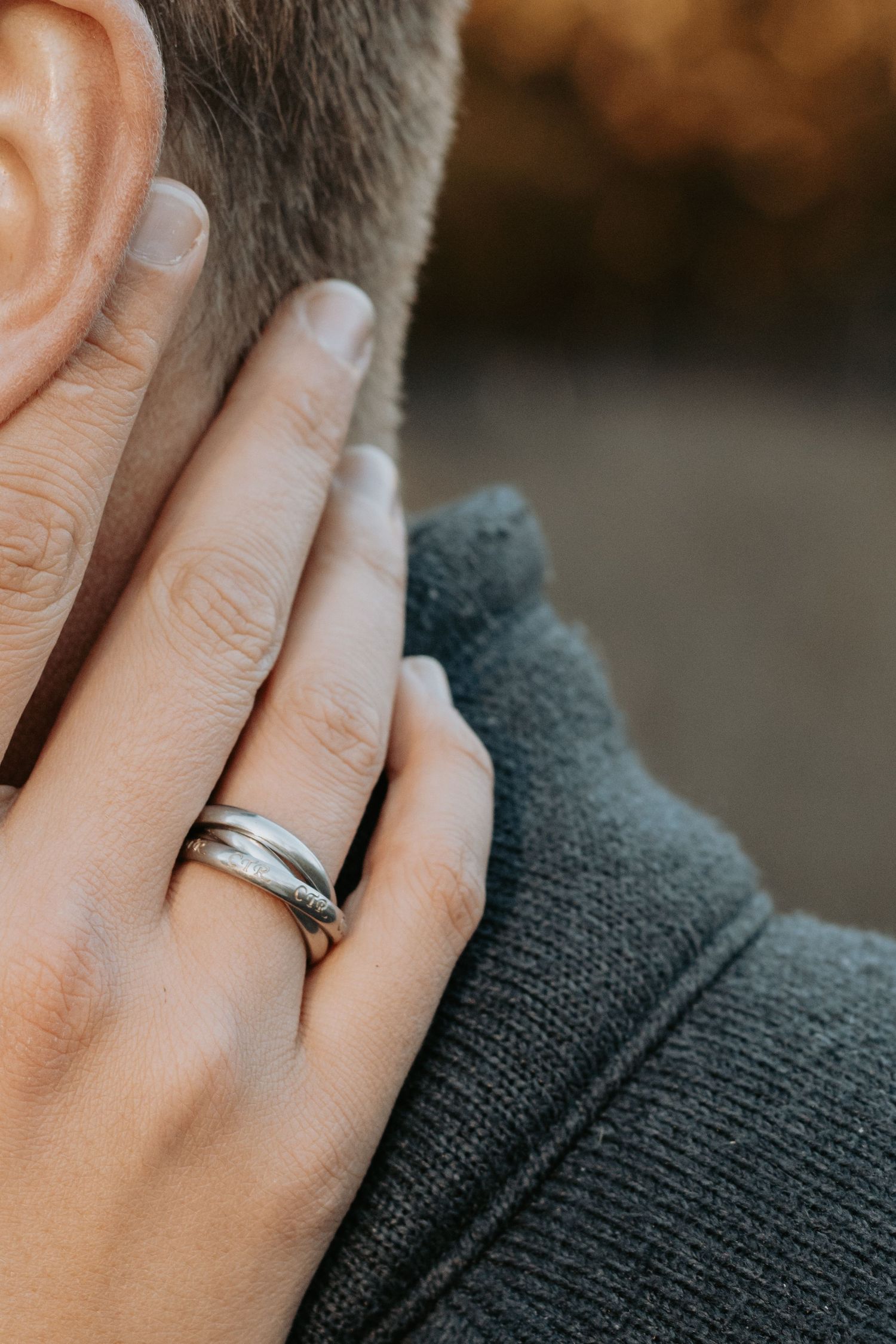 Couple sharing a gentle kiss in a quiet wooded area in Arkansas