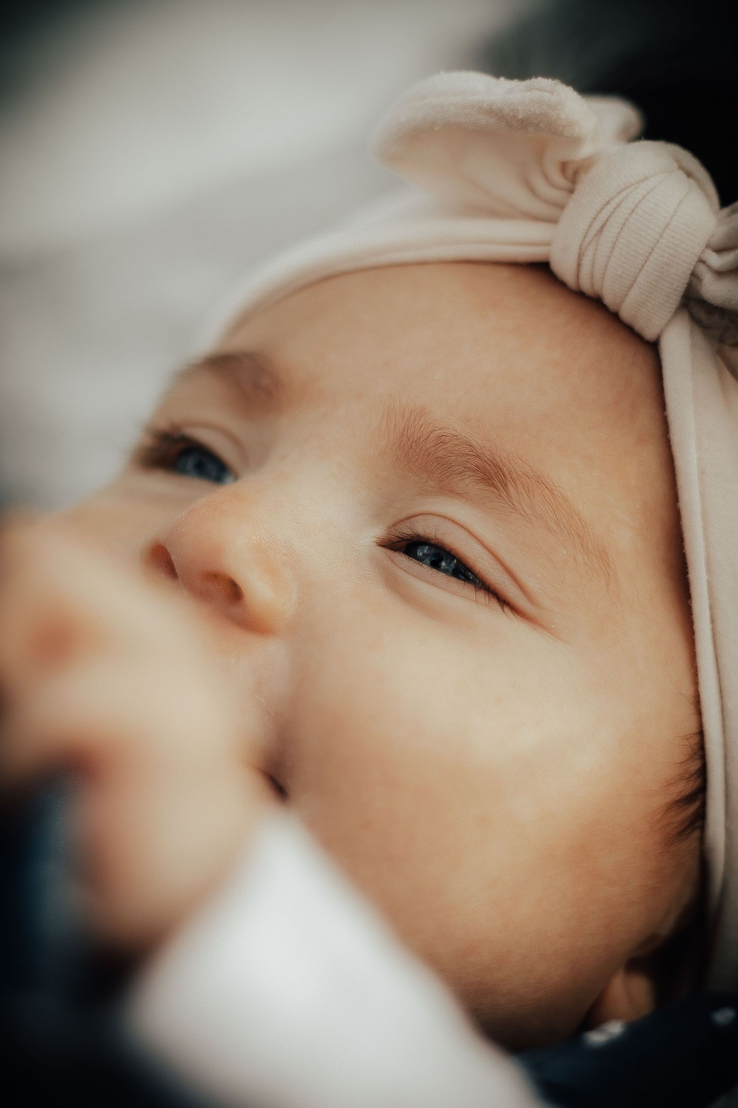 Newborn baby wrapped in a cozy blanket during lifestyle session in Bentonville Arkansas
