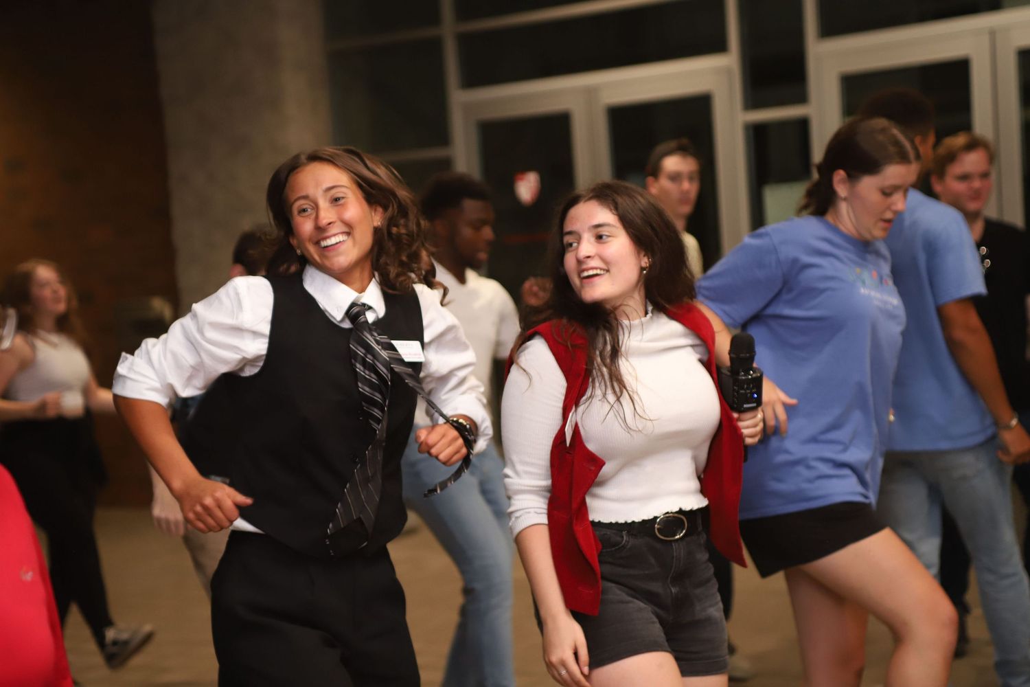 Students dancing and having fun at a casual indoor event.