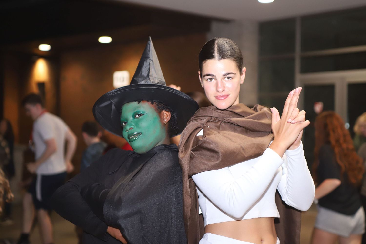 Halloween party scene with costumed attendees dancing.