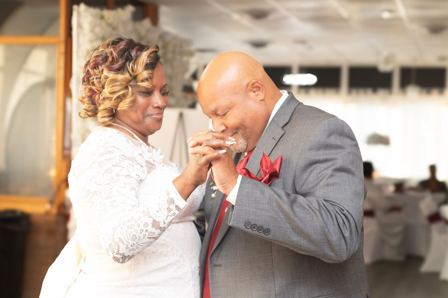 Elegant wedding reception scene with couples dancing in formal attire.