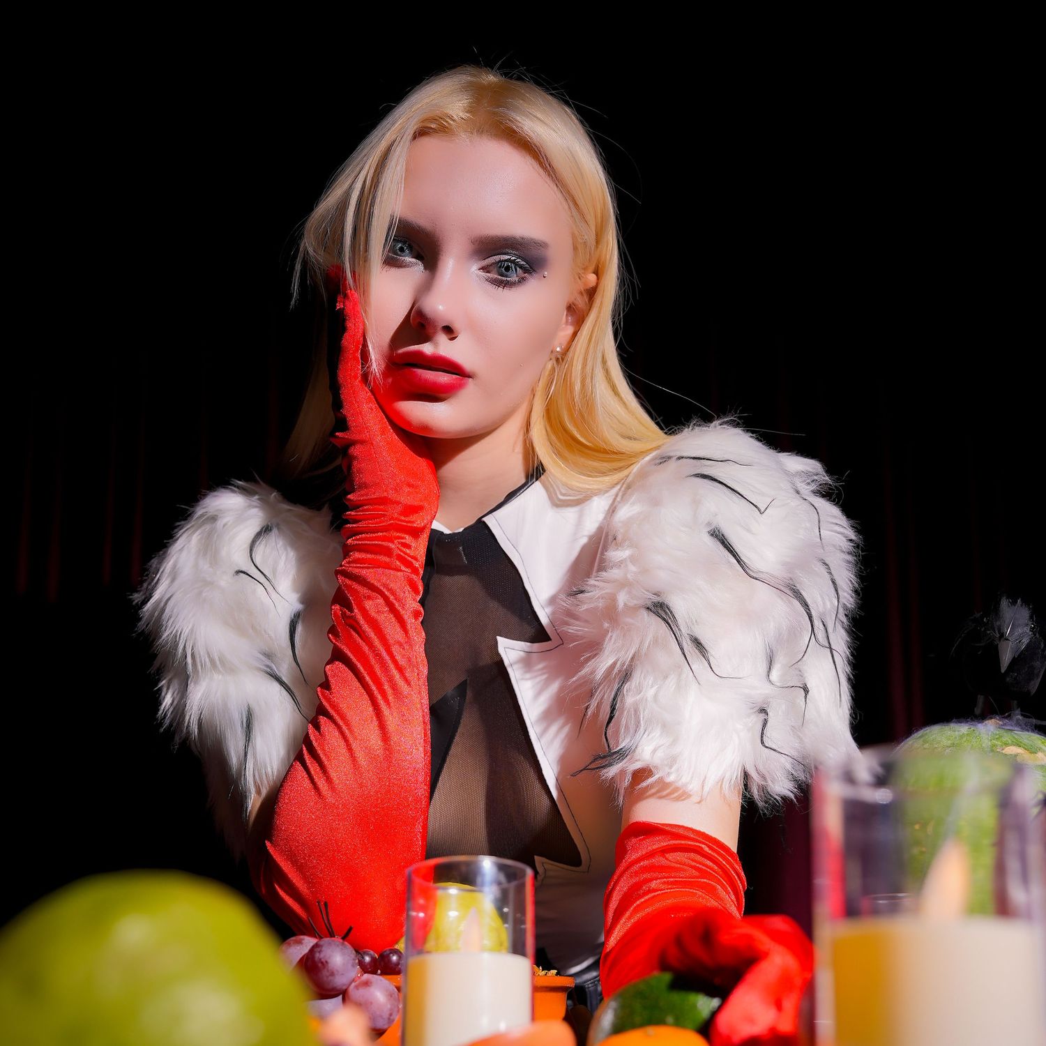 A glamorous figure in white fur and red gloves poses with cocktails and colorful drinks at an elegant bar setting.