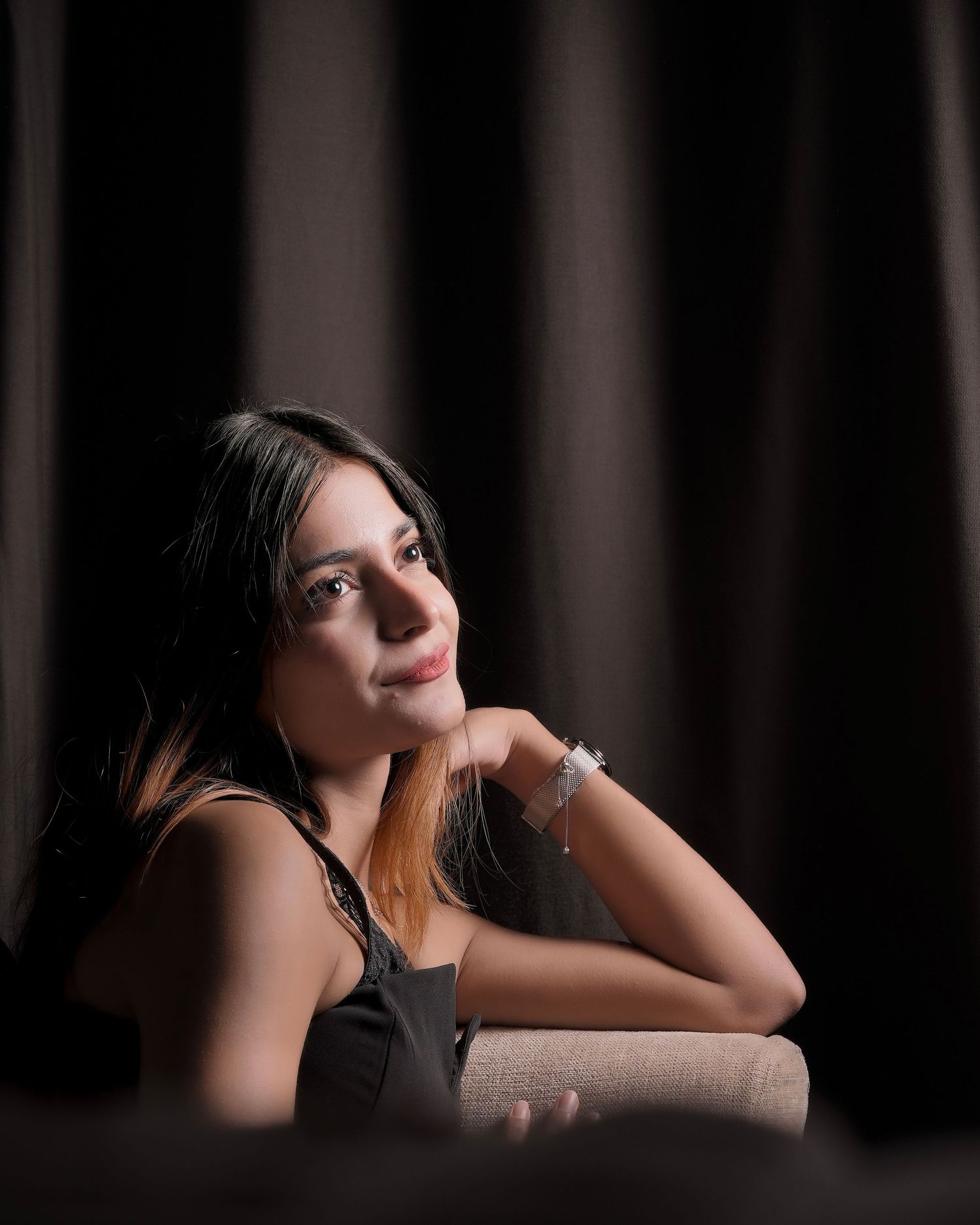 Artistic portrait series in dark moody lighting with dramatic shadows and poses.