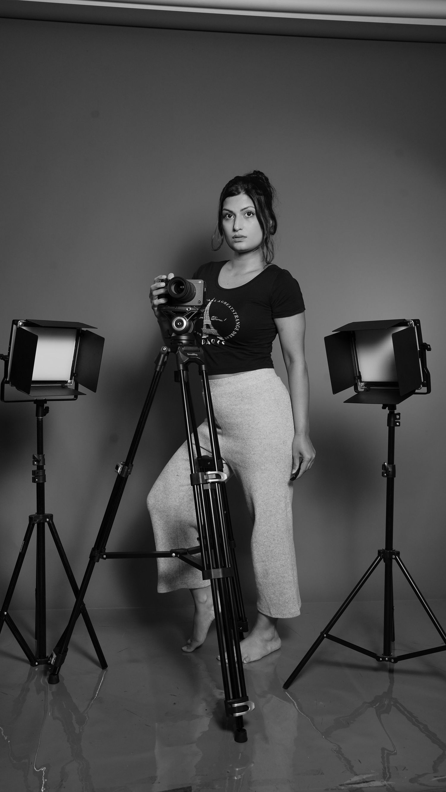 Black and white studio setup with photography lights and equipment.