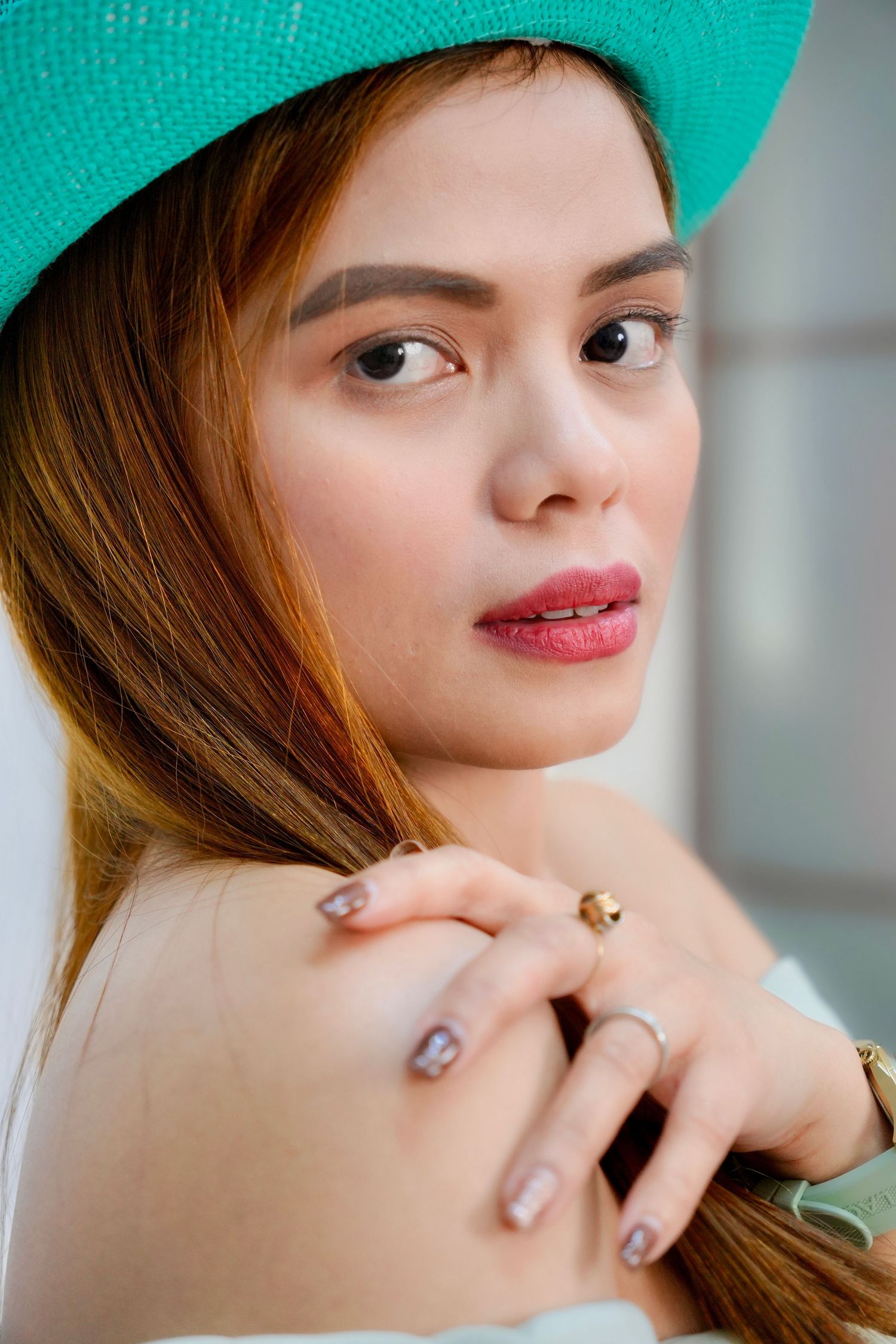 A portrait series showing close-up beauty shots with soft lighting and turquoise background.