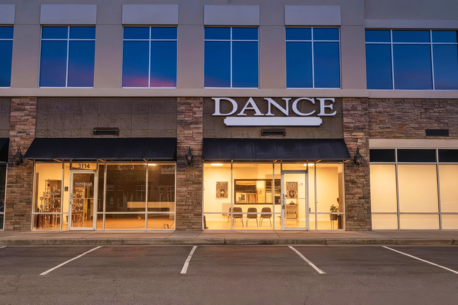Exterior of a dance studio storefront at dusk, featuring illuminated windows and bold DANCE signage on modern building.