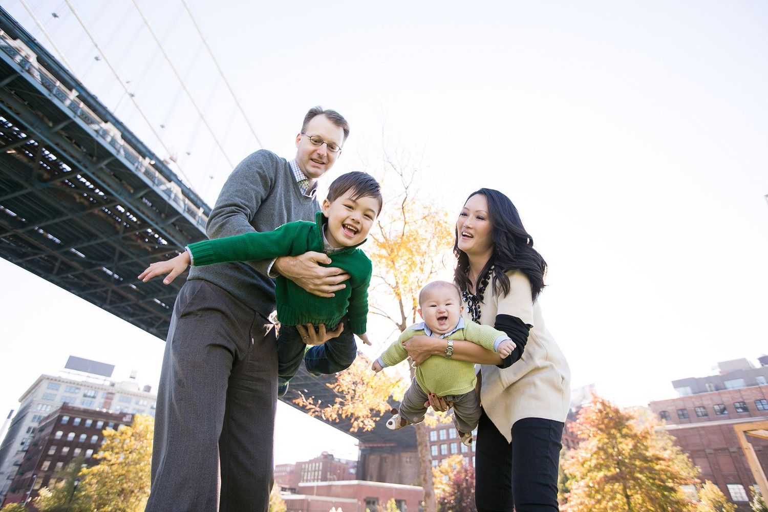 Family having fun together in urban setting with tall buildings in background.