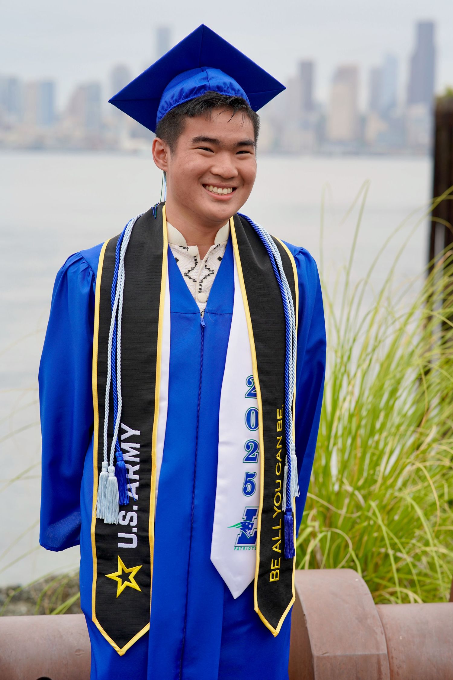 High school graduate celebrating with cap and gown during a graduation photo session in Port Townsend, Washington