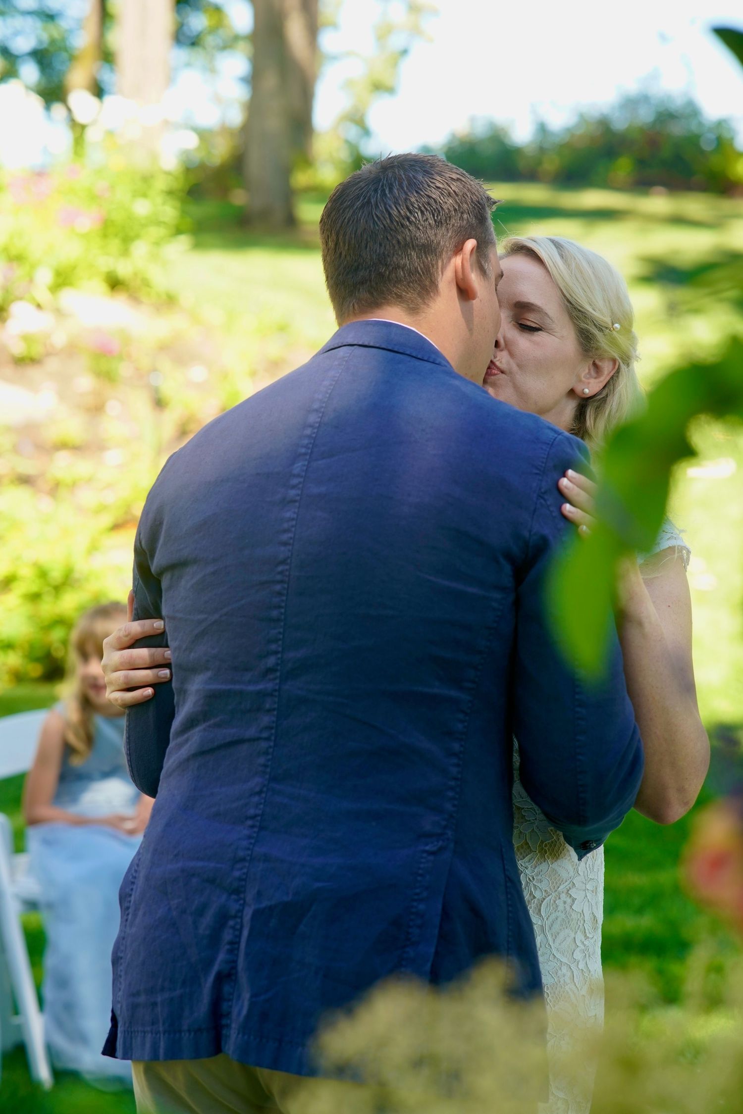 Wedding couple and family group gathered for a formal photo during an intimate wedding in Port Townsend, Washington