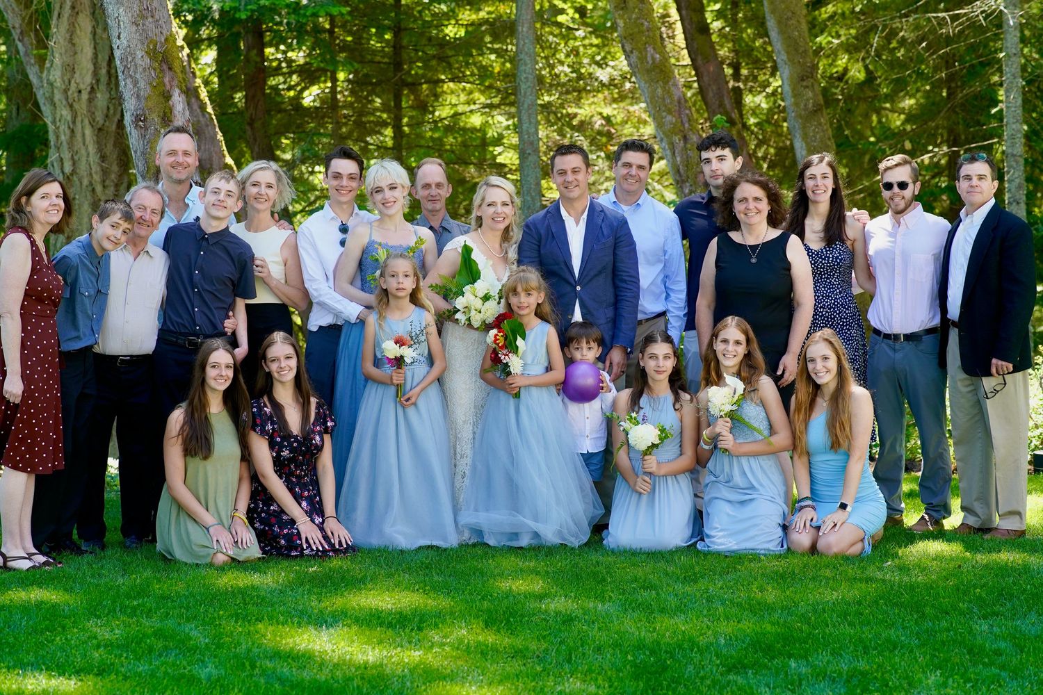 Wedding couple and family group gathered for a formal photo during an intimate wedding in Port Townsend, Washington