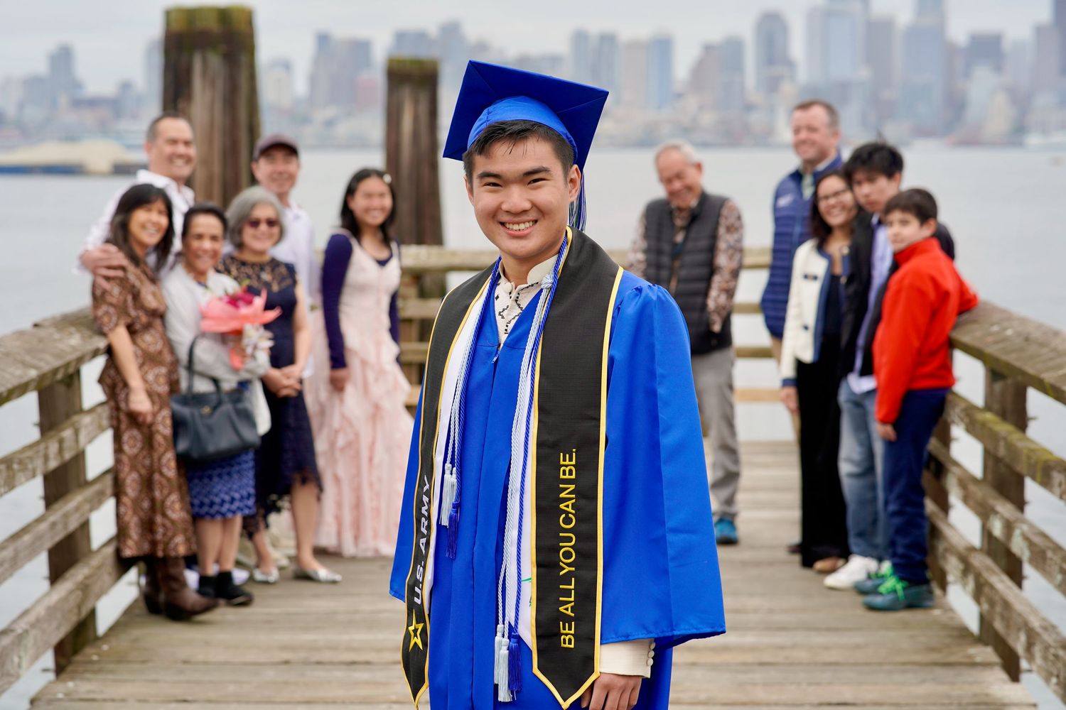 High school graduate celebrating with cap and gown during a graduation photo session in Port Townsend, Washington