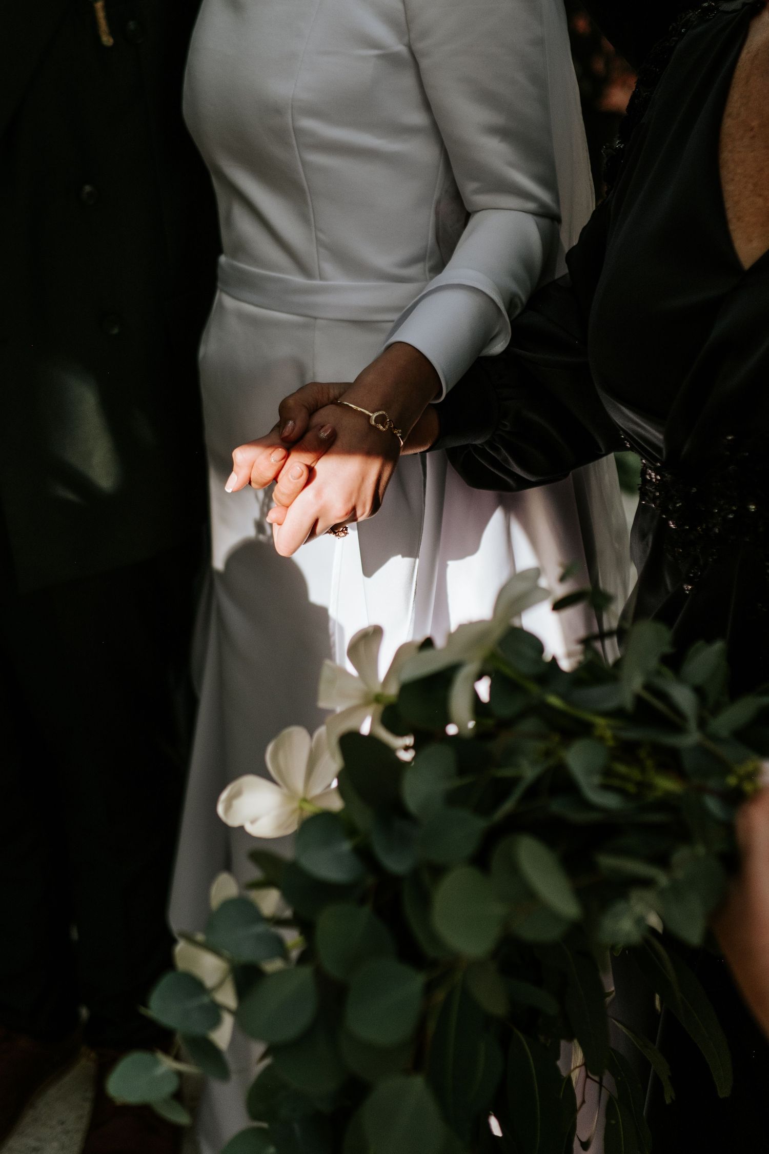 Holding hands in natural light during the ceremony