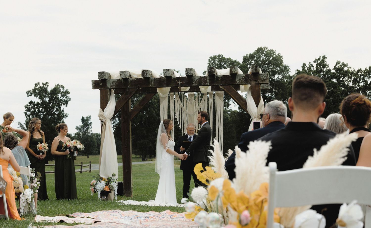 Bride and groom exchanging vows during an outdoor wedding ceremony