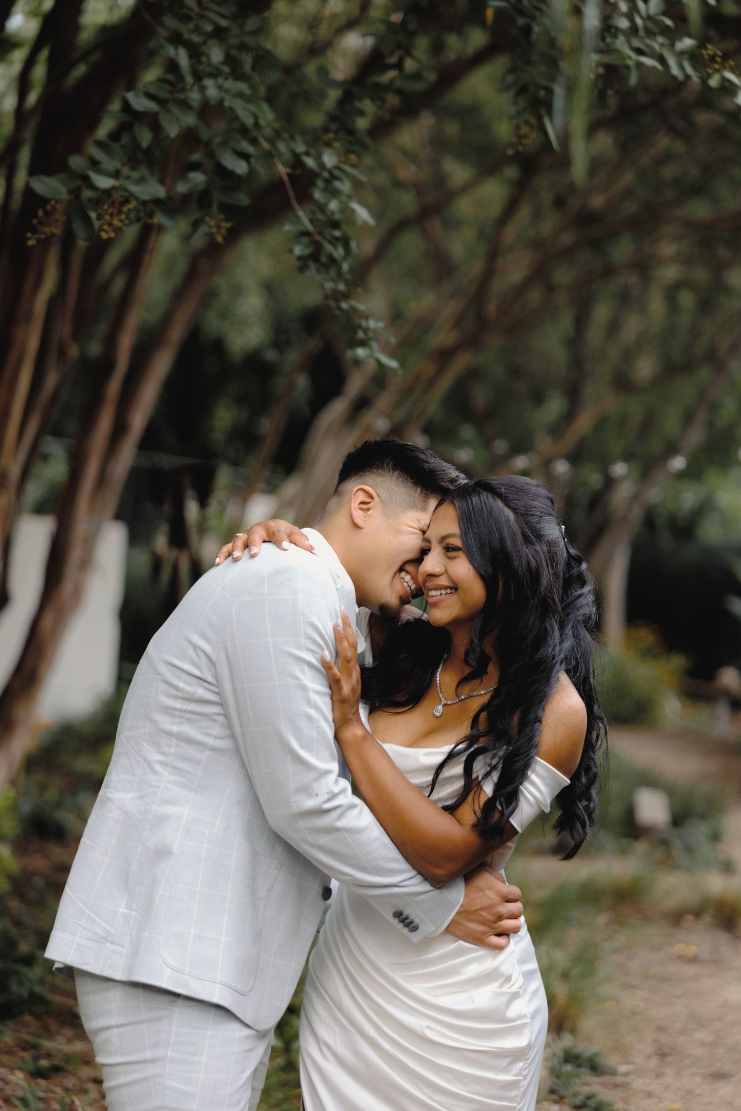 couple laughing together during a romantic outdoor engagement session