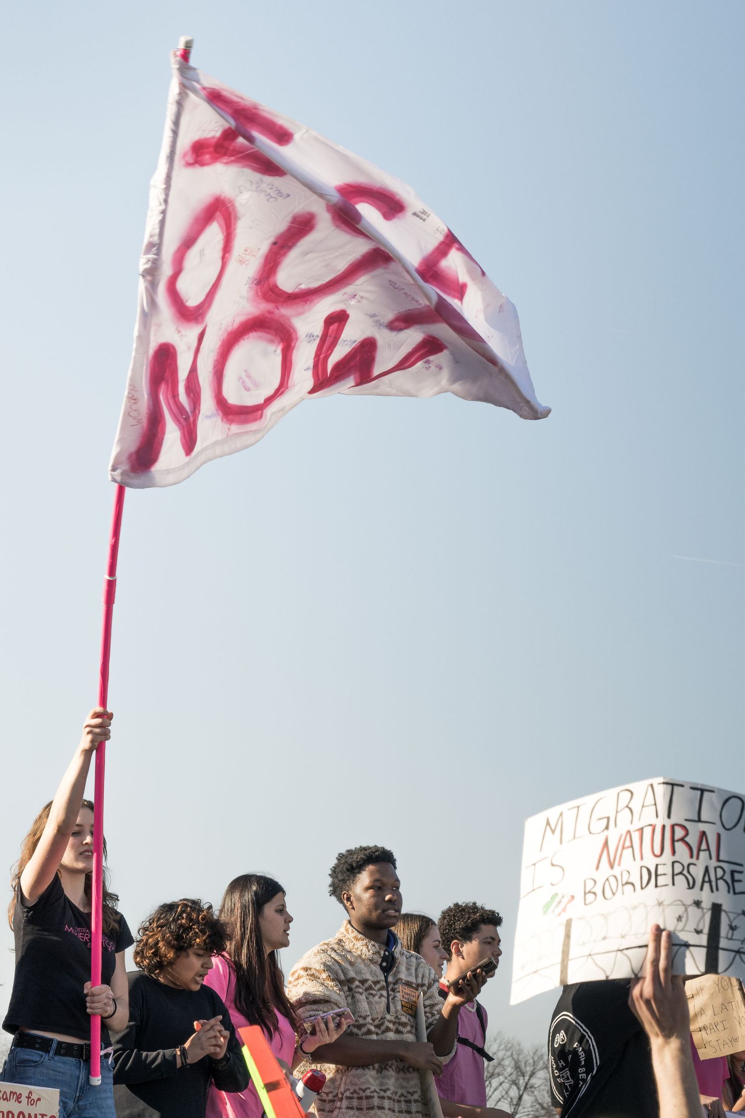 Washington, D.C. — February 27, 2026
Students gather with spray-painted signs reading 