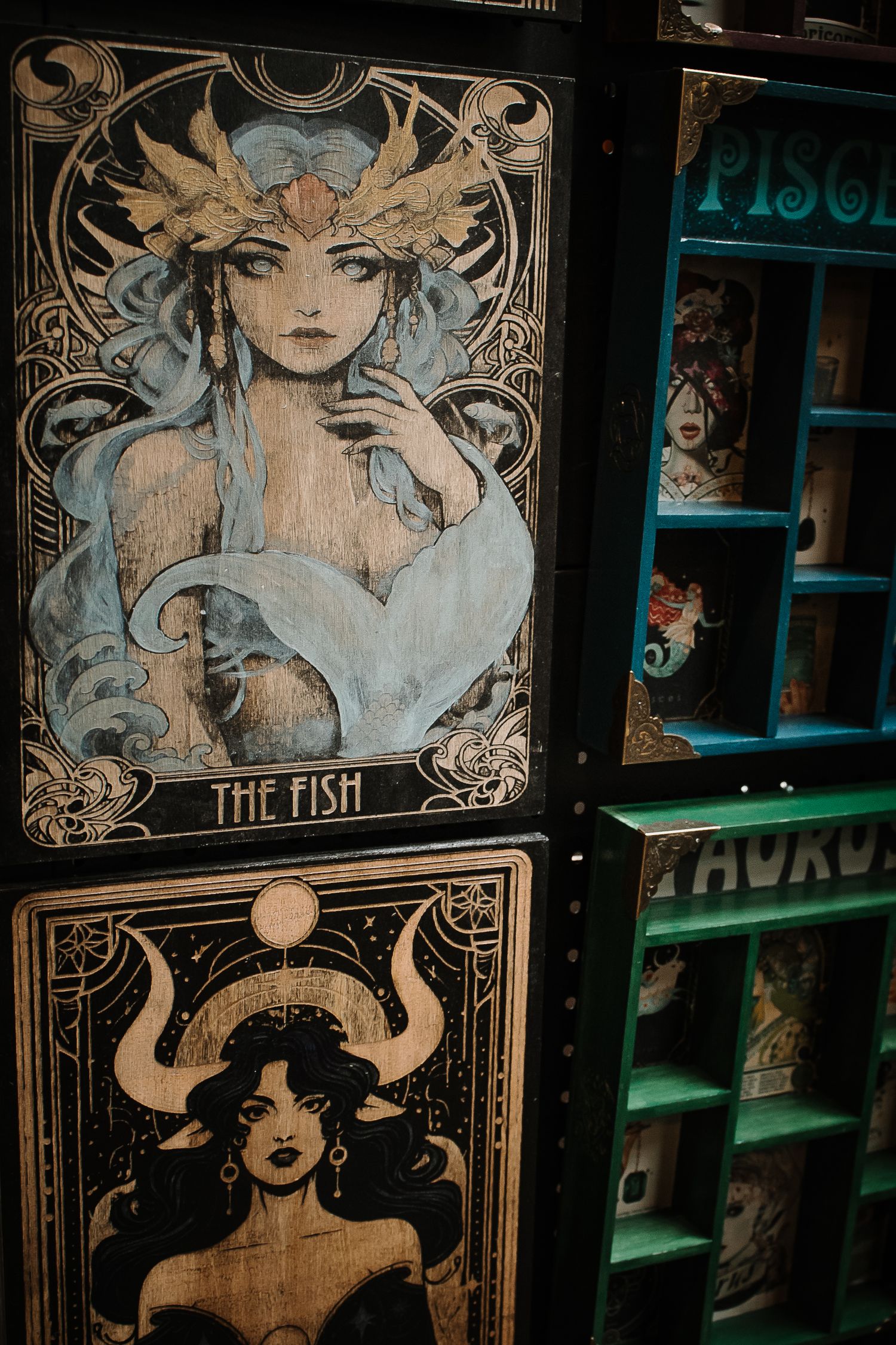 Art Nouveau style zodiac tarot card artwork featuring The Fish and Taurus signs.