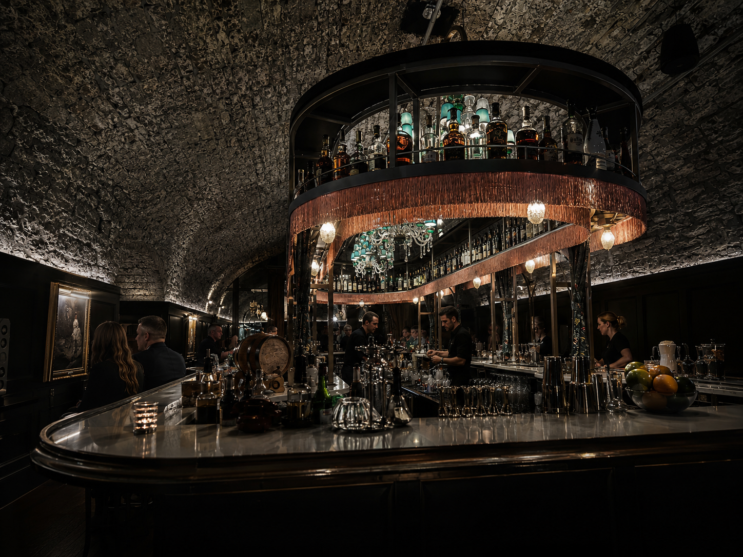 Dimly lit underground bar with arched stone ceiling, curved copper bar, and illuminated two-tier bottle display.