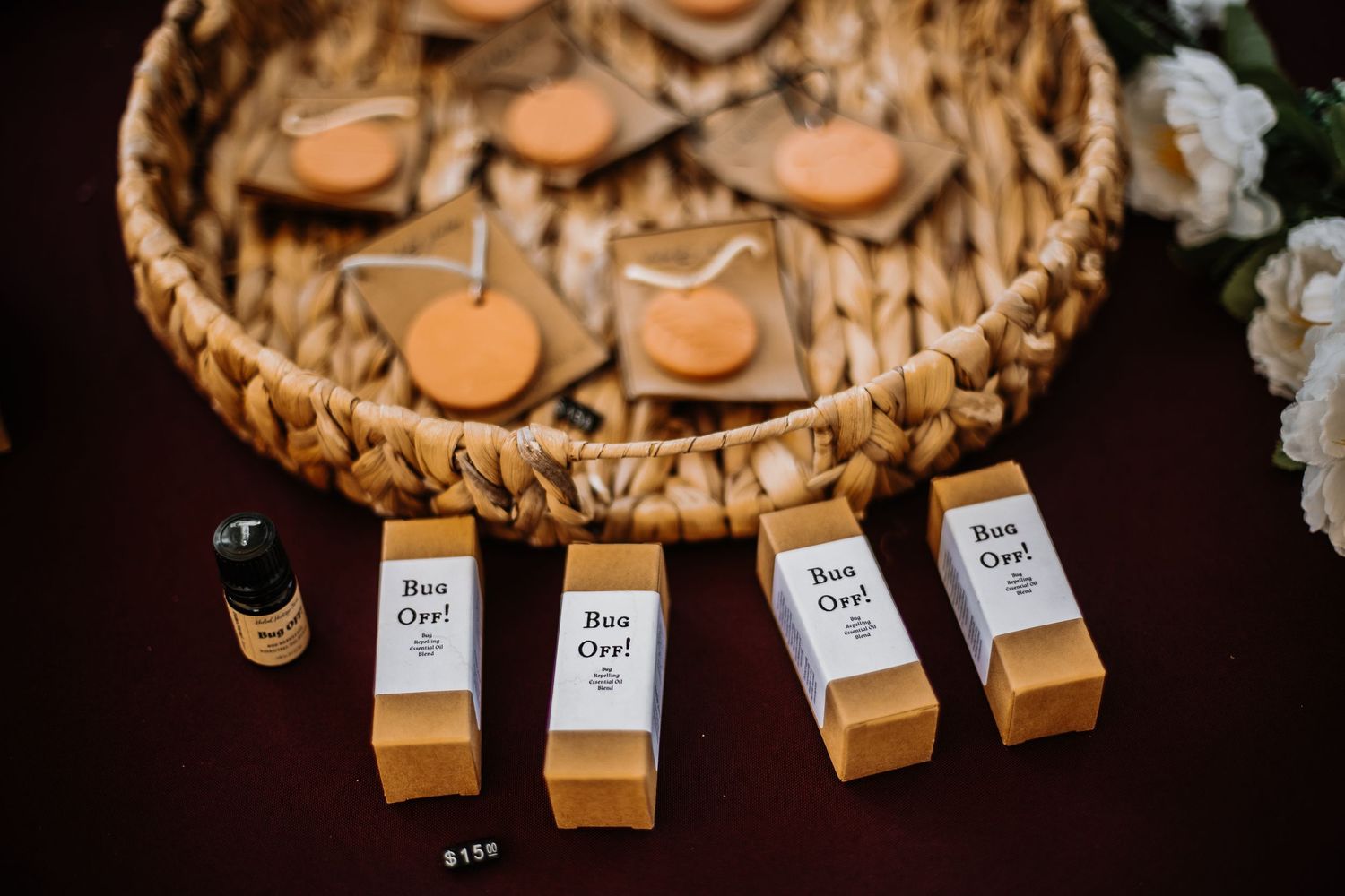 Kraft paper boxes labeled 'Bon Oya' displayed in a row beside a wicker basket of wooden tokens.