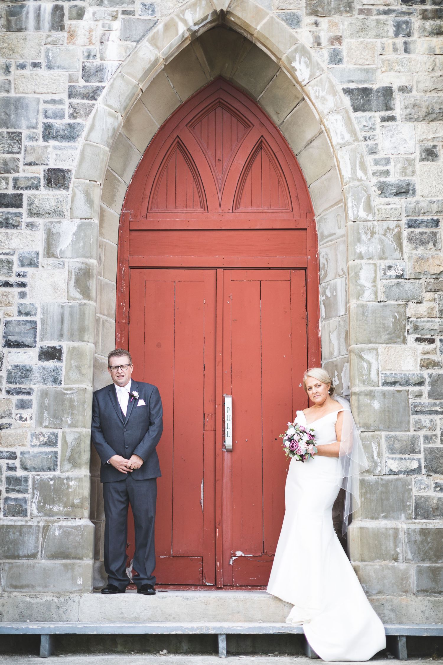 Portrait of a wedding couple in front of a church