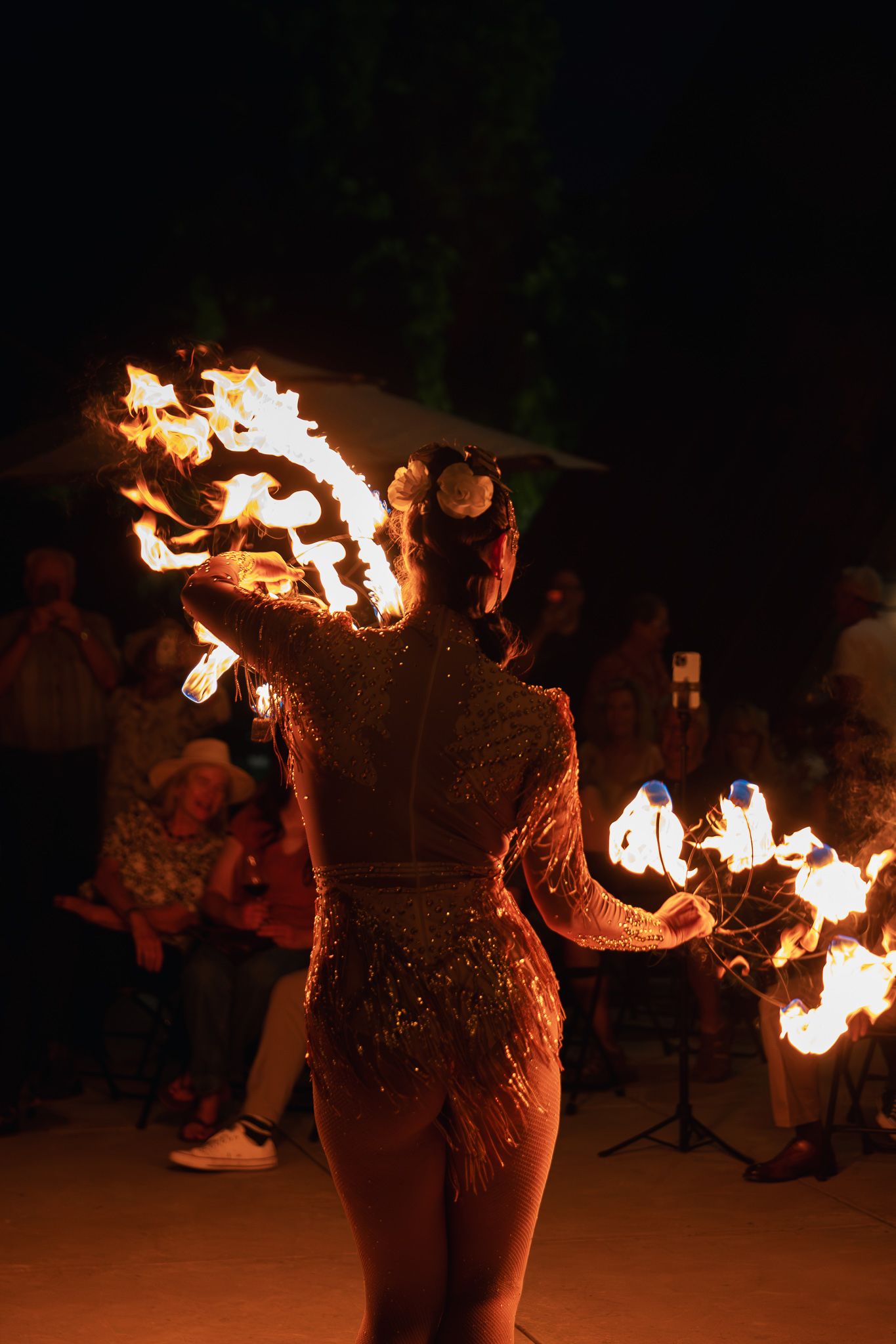 Fire dancer spinning flames at night during Shale Oak Winery's 15th anniversary party in Paso Robles