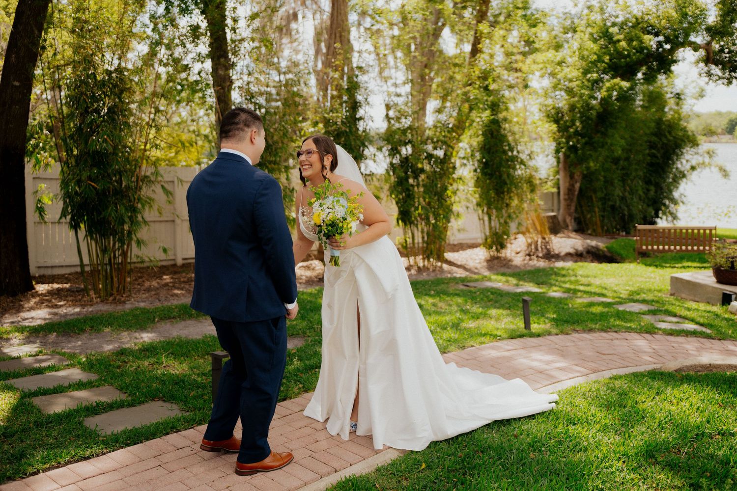 Two people share an intimate moment during their outdoor garden wedding ceremony on a sunny afternoon.