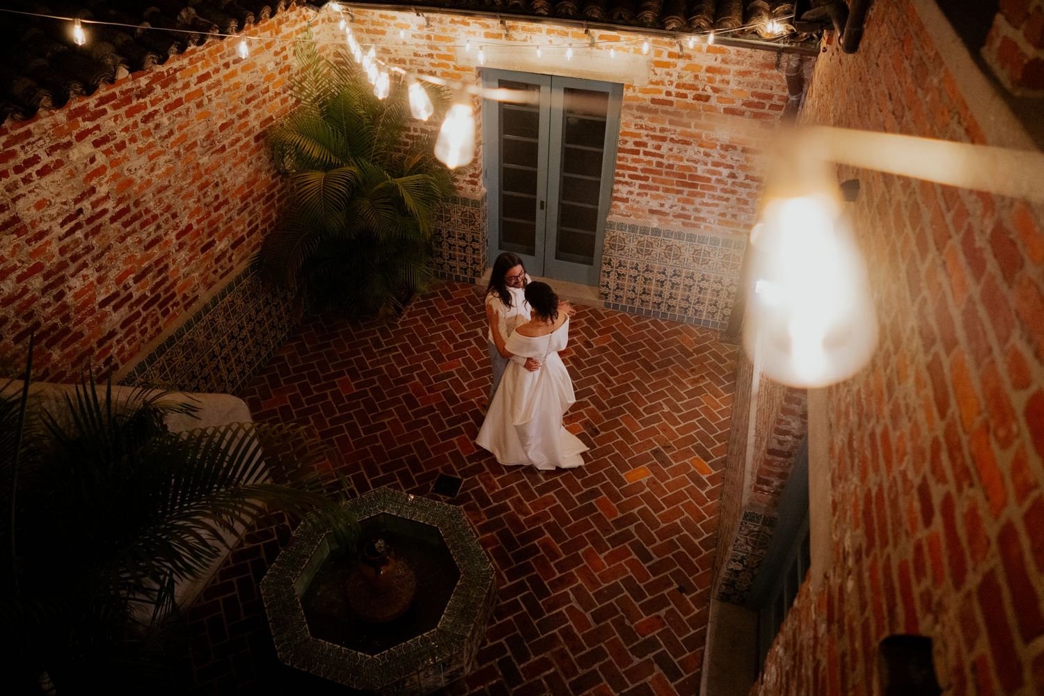 Elegant wedding venue with exposed brick walls and warm lighting creating a romantic ambiance.