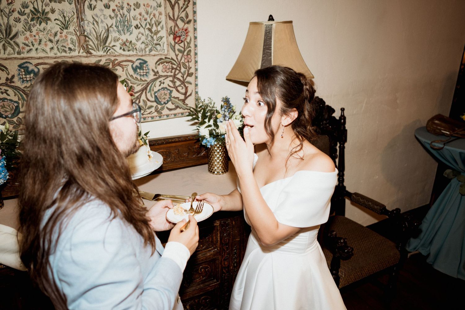 Two people share an emotional moment during wedding preparations in a cozy room.