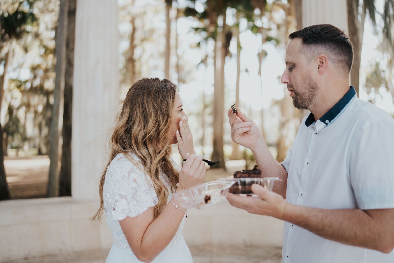 Couple shares excited reaction during special moment outdoors.