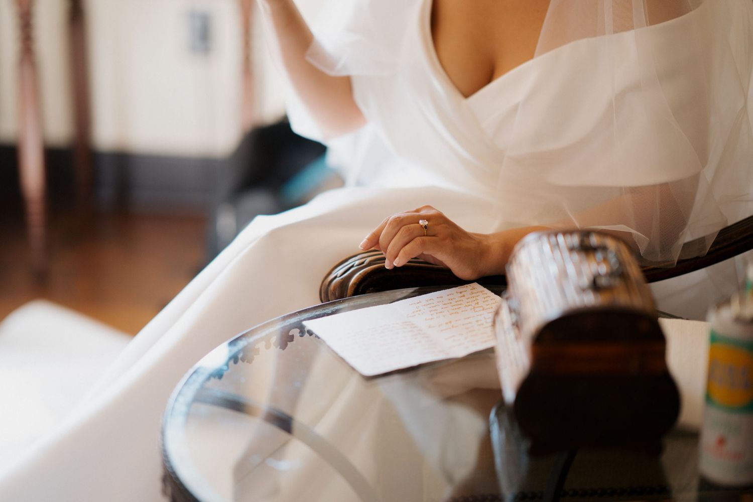 Medical professional in white coat examines patient records while sitting at desk in sunlit office.