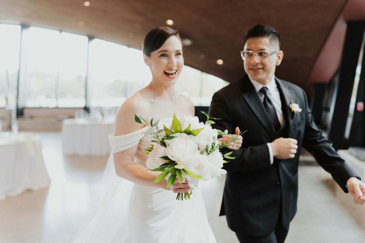 A series of black and white wedding photos showing candid moments between couples during a celebration.