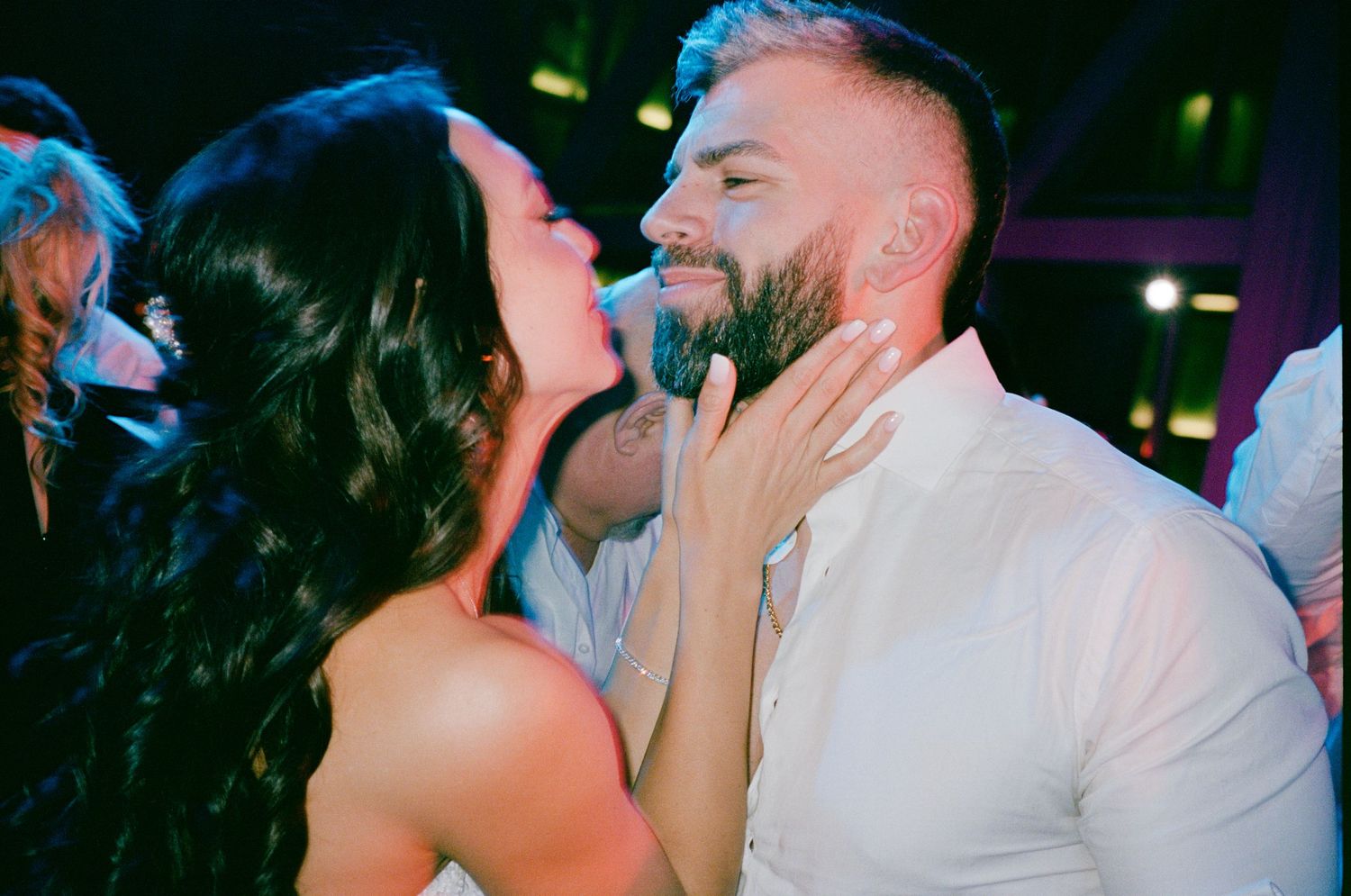 Couple sharing a romantic dance moment at a wedding reception celebration.