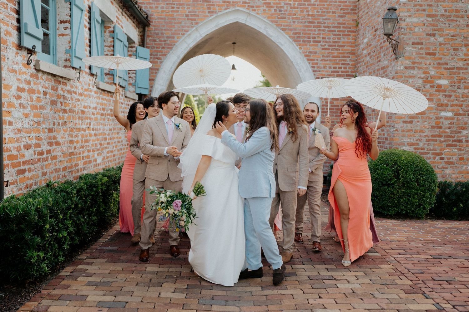 A series of candid wedding party moments captured against a rustic brick courtyard backdrop.