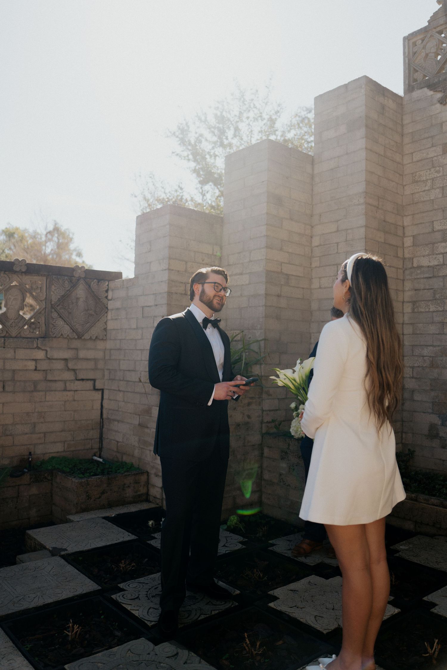 Wedding photo sequence showing couple walking through garden setting with stone walls.