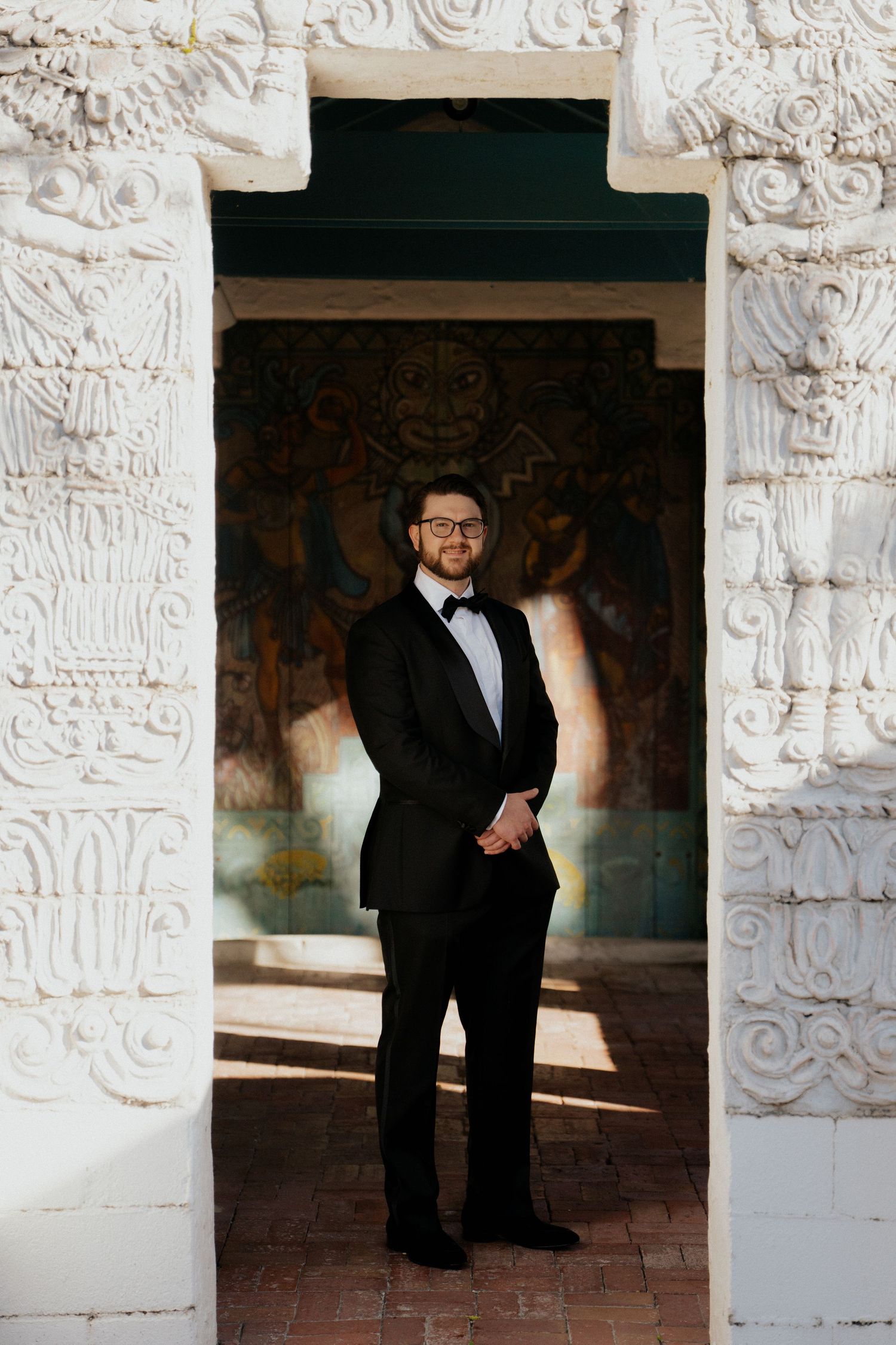A series of portraits in formal attire taken in an architectural space with ornate white carved walls.
